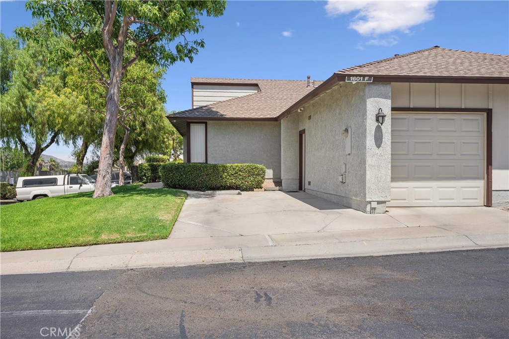 Welcome to this beautifully maintained and updated 2-bedroom, 2-bathroom townhouse in the highly sought-after Laurelwood Townhome Community. Located just minutes from the 15 and 91 Freeways and close to shopping, this move-in ready home offers both comfort and convenience. This home offers 1,027 sq ft of living space on a 2,178 sq ft lot, with a single-story layout that ensures easy living. The townhouse is well-kept inside and out, with an inviting open layout and vaulted ceilings throughout. Both bedrooms are spacious, each featuring its own ensuite bathroom, making it ideal for privacy. The attached garage and carport provide ample parking and storage, while the inside laundry room comes with washer/dryer hookups for both gas and electric connections. The kitchen is a standout, with original hardwood cabinetry, ceramic tile counters, and a newer porcelain sink (installed in 2021). Recent updates include a 2018 electric stove, 2021 overhead microwave, and 2007 dishwasher. Enjoy modern comforts with a newer HVAC system (installed in 2017) and dual-pane windows that help keep the home energy-efficient. The home also features a new water heater installed in 2021, so you can move in with confidence. Step outside to your fenced yard, perfect for private outdoor living. The community itself is a haven with amenities like guest parking, a pool, and a spa, as well as landscaping and exterior maintenance covered by the Homeowner Association. This well-maintained townhome is a fantastic opportunity in a desirable location, with easy access to major freeways and shopping. With the big-ticket updates already taken care of, all that’s left to do is move in and enjoy. Schedule a tour today!