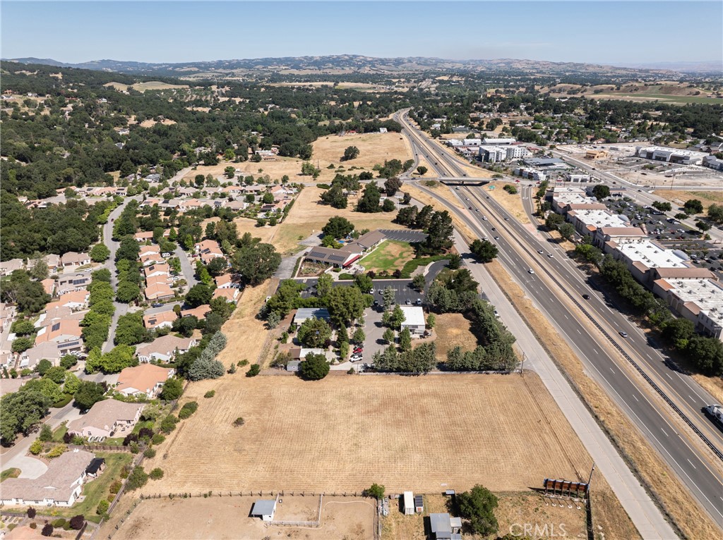 Incredible Development Opportunity – 2 Acres with Highway 101 Visibility
Flat and usable 2-acre parcel in prime North Atascadero that is already seeing dynamic new development activity and infrastructure investment. Seconds from the Del Rio bridge across the highway from new development (Valley Fresh) and on the same side of highway as the upcoming Barrel Creek Project on Del Rio. With approx. 200 feet of frontage along the well-traveled corridor with excellent visibility from Highway 101, this parcel offers outstanding exposure for future commercial or mixed-use development. Just minutes from Templeton and surrounded by exciting new development, this site is ideally situated for long-term investment or near-term development. The City of Atascadero has included this parcel in its General Plan Update, with proposed rezoning to “Innovation Flex”, a forward-thinking designation aimed at boosting economic growth, creativity, and flexible land use . General Plan Update anticipated Q4 2025 – buyer to verify.
Sellers have completed a Topographic Survey and have conceptual drawings for a 36,000+ sq ft mixed-use project featuring 4 office units, 8 light industrial/commercial units, and 3 residential tri-plexes. Parcel dimensions approx. 200’ x 440’.
Seller financing available with approx. 50% down, an incredible opportunity to secure this premier parcel with flexible terms.. Don’t miss this rare opportunity to invest in one of the Central Coast’s most promising growth areas.