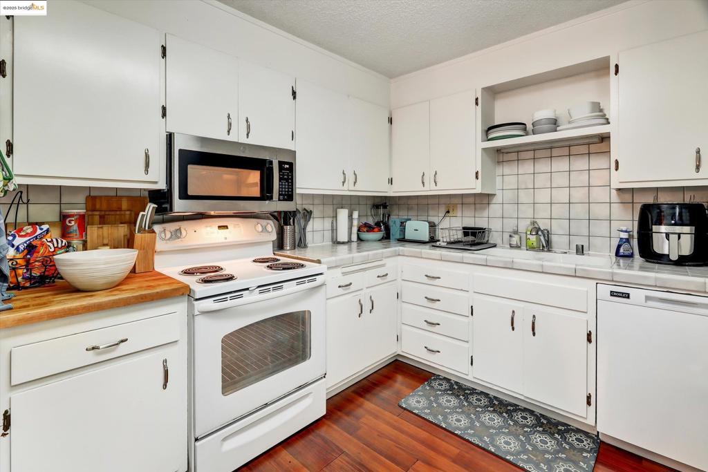 SATURDAY OPEN HOUSE: 2-4 PM. Superbly Located Hard to Find 3bed/2bath Condo situated in the Ultimate 'Steps to Campus' Location! Great sunny and bright spacious floor plan with 2 good size bedrooms bookend by 1 full bath with New sliding glass shower door over tub on one side of the living room and one completely private primary bedroom and bath with its own New sliding glass door that leads to the outdoor patio where you'll enjoy the peace and quiet of the hillside view. New Dual pane windows and 2 New sliding glass doors all w/ screens that allow you to enjoy the fresh summer breeze. Painted from top to bottom including the ceilings in the last few years. Fully Equipped Kitchen features New SS Microwave, Dishwasher, Dual sinks with G/D, Partial Butcher block counter top w/ plenty of cabinet space, and an eat-in nook. Condo has 1 assigned parking space and laundry area in the garage. LR/dining area has Cherry laminate flooring w/ sliding glass door leading to a nice balcony to enjoy the outdoors. Close to walking trails, shops, restaurants, Downtown Berkeley, Telegraph Ave, Haas & International House, Claremont Hotel and BART!