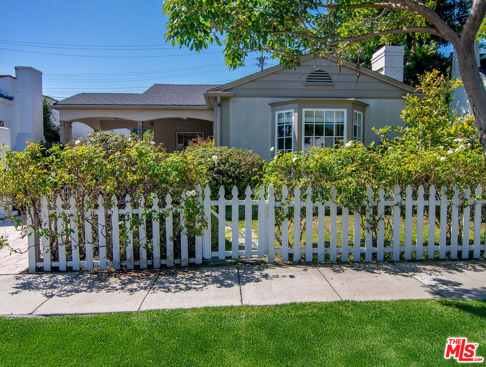 This is the perfect West Hollywood Bungalow, completely and stylishly remodeled and ready to move right in. The main house features gleaming wood floors and boasts 2 bedrooms and 2 baths with a sun drenched living room w/cozy fireplace and large beautiful bay windows overlooking a lushly landscaped front yard that is perfectly framed with the "white picket fence" you've always wanted. The formal dining room sits adjacent to the chef's kitchen with center island, stainless steel appliances and glass front display cabinets. There is also a huge separate laundry room with tons of storage & pantry closets. The primary suite has side by side closets and a spa-like bath with soaking tub and separate shower. The very private rear yard has mature landscaping and low maintenance hardscape pavers including a detached/permitted bonus room with a half bath. Amazing location close to all the best dining, shopping and entertainment in L.A.