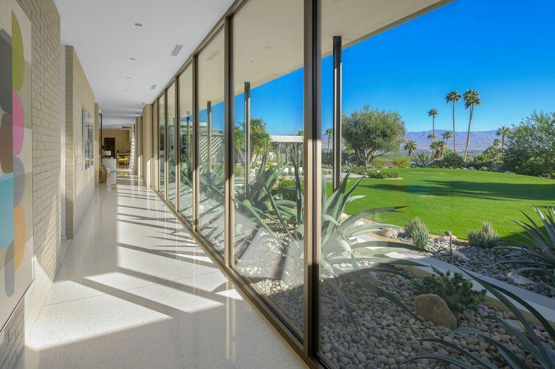 This mid century designed estate is sequestered at the top of a cul-de-sac at Rancho Mirage's guard-gated Thunderbird Heights. The residence exhibits a recently built home that captures the classic vintage vibe while incorporating today's preferred amenities. Views impress in all directions, from incredible valley floor panoramas to a dramatic mountain backdrop. Showcasing a single-level floor plan of approx. 5,601 s.f., the home reveals floor-to-ceiling windows, numerous indoor/outdoor spaces, and terrazzo flooring inside and out. Discover 3 bedrooms and 3.5 baths in the main house, an office, and 2 outdoor guest suites. An entry with skylight and pivoting front door opens to a spacious living room with a fireplace, floating hearth and custom room divider screen. Furnishings provided by noteworthy designer 'Maison Inc' are featured in every room, including a family room with walk-in wet bar. The kitchen and dining area displays a double-waterfall island and top appliances. Private grounds encompass a double homesite of nearly 1.3 acres that features a pool, fireplace, built-in BBQ, expansive lawns, enchanting gardens, pool bath, yoga platform and a meditation garden just outside the primary bedroom. Architecture by Stuart Silk, landscape by Anne Attinger.