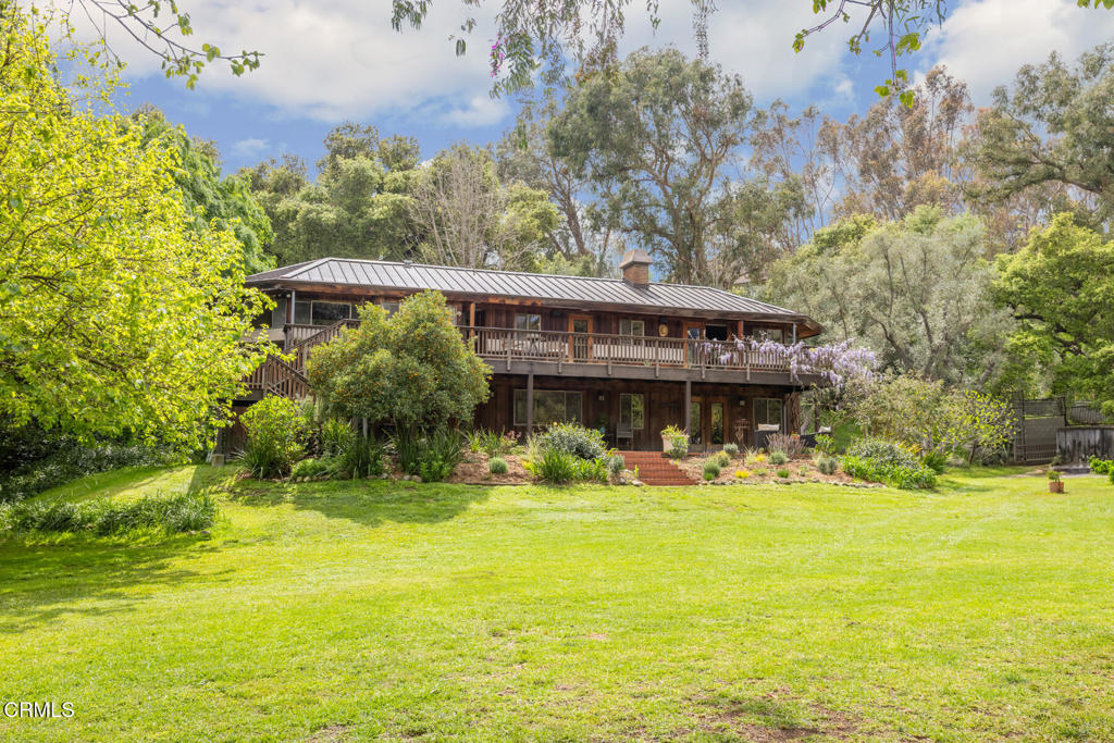 A rare two-for-one opportunity with two homes on over an acre of land! Set on a private, sprawling lot, this stunning La Canada Flintridge estate offers a captivating blend of distinctive architecture and natural beauty. The property was originally marketed as an equestrian's dream, complete with 'room for horses to roam, including a training ring and multiple corrals.' Still zoned for equestrian use, the property maintains its heritage with a large corral and easy access to nearby riding trails. Today, the estate features a striking 2,980-square-foot residence built in 1969. Large fir beams and vaulted ceilings lend warmth and depth, while expansive windows and skylights flood the home with natural light and showcase stunning views of the San Gabriel Mountains and sweeping lawns. Two bridges offer unique entry points. The lower bridge brings you through a dramatic 15-foot door into a formal, skylit entryway. The upper bridge leads into an inviting galley kitchen with butcher block countertops, a commercial-grade antique Wolf stove, stainless appliances, built-in bar, and panoramic views. A formal dining room flows into a grand living room anchored by an original 56-inch adobe brick fireplace. Downstairs are four bedrooms and three baths, including a spacious primary suite with its own fireplace and private patio overlooking the grounds. A sizable basement includes laundry, a utility sink, and generous storage space. Next to the main home is the original 989 square-foot guest house. Renovated in 2018, it features vaulted ceilings, its own fireplace, butcher block counters, Thermador stainless appliances, and commercial-grade laundry. Dual entrances lead to a large wraparound patio. The lush, lovingly maintained grounds host mature fruit trees--orange, lemon, fig, persimmon, apple, apricot, kumquat, mulberry, and pomegranate. Close proximity to Blue-Ribbon Schools, Foothill Blvd, local shopping, dining, and freeway access.