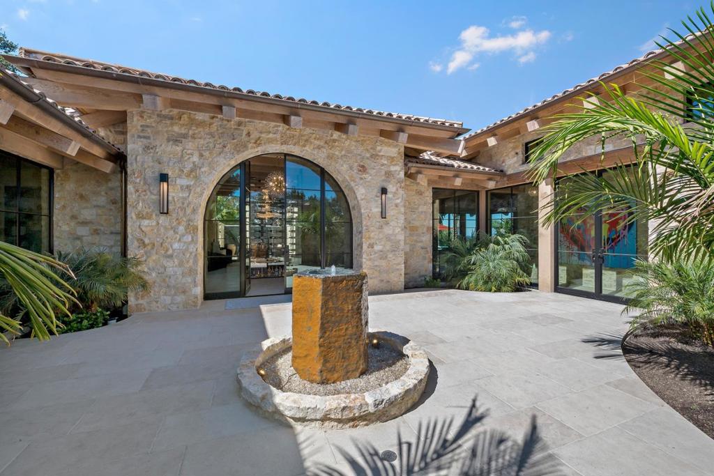 Just-completed one-level vineyard estate with San Francisco Bay views. Built with natural stone walls inside and out and vaulted all-wood ceilings in every room. Nearly every room has French limestone floors, cabinetry is waterfall-wrapped in natural quartzite, and handcrafted iron doors are inspired by Tiffanys in New York. Unique see-through wine cellar upon entry, formal dining room opens to a waterfall wall, and stunning great room for entertaining. The primary suite has a couture closet room and spa-inspired bath. There are 4 bedrooms and 3.5 baths in the main home plus 2 bedrooms and 1 bath in the updated original guest house with full kitchen. Outdoor living spaces are spectacular with a zero-edge pool and spa, kitchen/dining lounge with pizza oven, vast eco-friendly lawn, fire pit terrace, and bocce court in the vineyard. Exceptional dog run and custom tortoise enclosure for the animal lover. Square Footage Breakdown: Main Residence: 4,887 | Garage: 782 | Guest House: 1,184 | Total: 6,853. Buyer to verify.