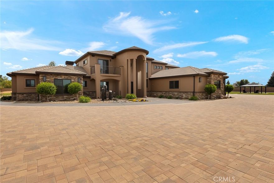 Luxury Private Estate in the Heart of Chico

Tucked behind a six-foot split-faced block wall with three gated entrances, this extraordinary 3-acre estate offers unmatched privacy, space, and high-end living—right in the heart of Chico.

At the center of the property stands a breathtaking 5,095 sq. ft. custom home, built in 2019 with attention to every detail. Designed for both luxury and functionality, this home features 4 spacious bedrooms, 3.5 bathrooms, and premium finishes throughout.

Step into elegance with soaring 22-foot ceilings in the foyer and great room, rich hardwood flooring, solid alder doors, and handcrafted walnut cabinetry. The chef’s kitchen is a showpiece, outfitted with Wolf and Sub-Zero appliances, concrete countertops, and custom design touches that bring beauty and performance together.

Enjoy:

- A massive 78-panel **owned** solar array (mounted on the shop roof)

- Heated marble flooring and a custom concrete soaking tub in the master suite

- A striking 10-foot commercial gas fireplace anchoring the open-concept great room

- Custom ironwork throughout, including a statement staircase

- A fully equipped 10-seat movie theater with a 6’x12’ screen

- Milgard windows and doors that flood the home with natural light

- Integrated state-of-the-art audio/video and full-property security camera systems

Adjacent to the home is an 8,450 sq. ft. fully insulated Butler building—complete with four 16-foot roll-up doors, a 20-foot concrete apron, office/studio and 800-amp electrical service. It’s the perfect space for large-scale hobbies, a car collection, equipment storage, or business needs.

Outside, over 18,000 sq. ft. of concrete pavers and drought-tolerant landscaping create a clean, impressive exterior with minimal maintenance required.

Another major advantage: this estate features its own private well, offering reliable and independent water access.

Perfectly located, you’ll enjoy the peace and space of country living while being just a short drive from both the Bay Area and Lake Tahoe—giving you easy access to world-class entertainment, dining, skiing, and coastal adventures.

This is more than a home—it’s a private, high-end retreat designed for those who value craftsmanship, privacy, and a lifestyle without compromise.