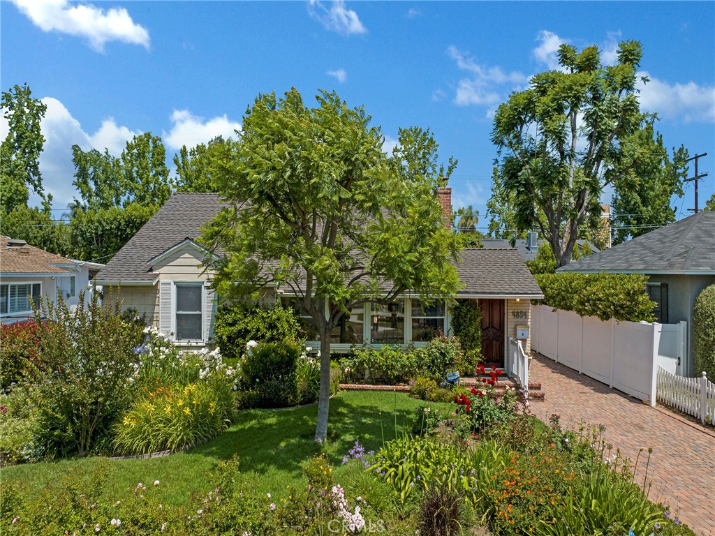 Situated in a picturesque neighborhood with beautiful tree lined streets, this home is located within the highly coveted Fashion Square neighborhood of Sherman Oaks. The living space is open with large windows that floods the space with natural light. The generously sized living room has views of the lush manicured front yard. The kitchen has custom cabinetry with lots of storage, double ovens and a SubZero refrigerator. The dining area is conveniently located near the kitchen and features a wall of windows looking out to the backyard courtyard. The large primary bedroom suite is a sanctuary, boasting a beautiful marble fireplace, vaulted ceiling, a sliding door with views of yard and has a walk-in closet. The primary bathroom has dual sinks and a separate tub and shower. The rear yard offers optimal privacy with walls of hedging, brick and pavers, fruit trees and mature gardens. There’s a lovely private shady spot behind the primary suite that’s perfect for a quiet cup of coffee, an al fresco dinner or a quiet spot to relax and unwind. This exceptional home has a detached 2-car garage and a separate fenced space for trash cans and other items that you may want to store out of sight. Nestled in a prime neighborhood, this home is just moments away from everything Sherman Oaks has to offer such as renowned restaurants, trendy shops, parks & so much more. With easy access to freeways and major commuter routes makes getting around town a breeze. Awaiting your personal touches, this home invites you to transform it into your dream residence. Don’t let this rare opportunity get away!
