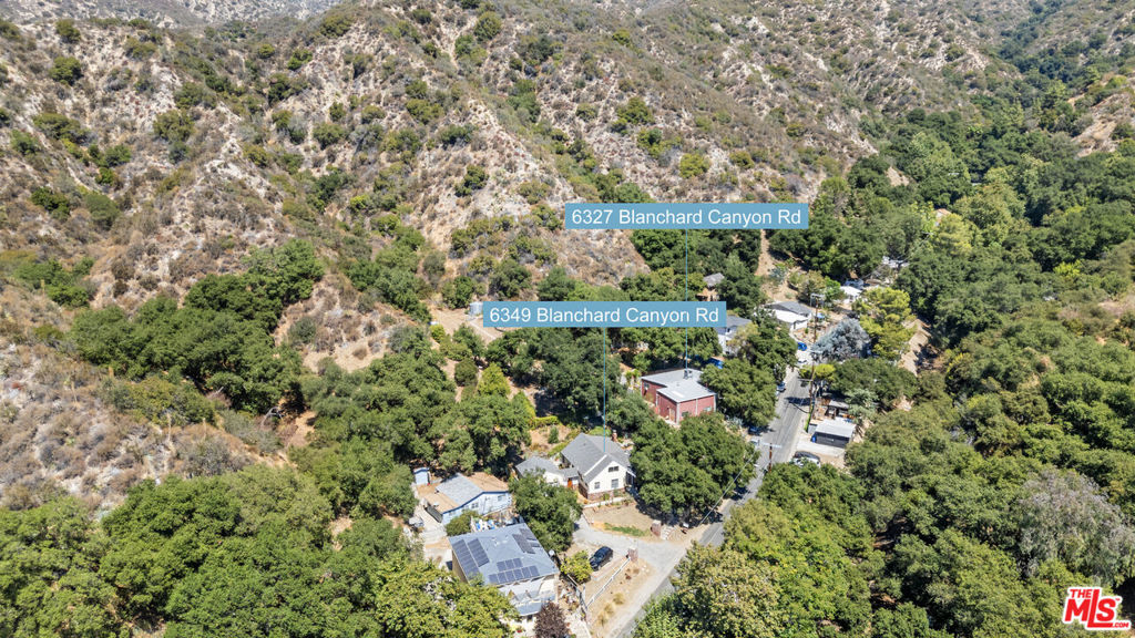 This property is an exceptional and rare opportunity to own 2 houses on separate lots plus a huge 3rd lot (18 acres) offering privacy, serenity and natural surroundings. The 6349 Blanchard Canyon lot has a 3 bed 2 bath house with original charm, large primary bedroom with lovely wood beamed ceilings, private bath and lots of windows overlooking the back patio. This house also features a large living room with built-in bookshelves, a separate dining area, laundry, hardwood floors and large 2 car garage. The 6327 Blanchard Canyon lot has an 1,800 sq ft 1 bed 1.5 bath house with amazing open living room space, plus workshop/office and 3 lofts for a multitude of uses. This inspiring home and workshop has high ceilings, cement floors, roll up garage door, great A/C and two storage sheds. Outside, multiple garden spaces create the perfect setting for relaxing, entertaining, or simply enjoying nature, quiet and butterflies. The flexible spaces create options: family compound or private retreat, or rent one house and live in the other or separate the lots. The property is just minutes to the charming Montrose Village, cafs, shopping and farmers market. Easy access to the 210 Freeway. With no rear neighbors, enjoy close proximity to Angeles National Forest, Deukmejian Wilderness Park, and Haines Canyon Trails, a paradise for hikers, bikers, and nature lovers in a scenic neighborhood. The 3 bedroom house is tenant occupied. Please do not disturb occupants.