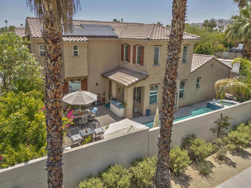 Rare gated Village Traditions gem! Stunning stand-alone home on a premium oversized corner lot with private saltwater pool/spa and breathtaking mountain views. Located steps to downtown Palm Springs and minutes from hiking trails. Meticulously upgraded 3BR/3BA featuring dual primary suites (one up/one down), soaring vaulted ceilings, and open floor plan. Loft off of the upstairs primary retreat can be used for another office space, gym space, den, or second sitting area. Gourmet kitchen with quartz counters, plus laundry room and 2-car garage with guest parking. Premium upgrades include owned solar, soft water system, elegant flooring, stainless appliances, and energy-efficient windows. Private backyard paradise with smart-controlled pool/spa, Sonos sound system, and dog run, perfect for pets. Upstairs master showcases mountain-view balcony. HOA covers internet, water, and trash. Perfect as a primary residence, vacation retreat, or investment property. Contemporary luxury meets resort-style living in Palm Springs' most sought-after neighborhood.