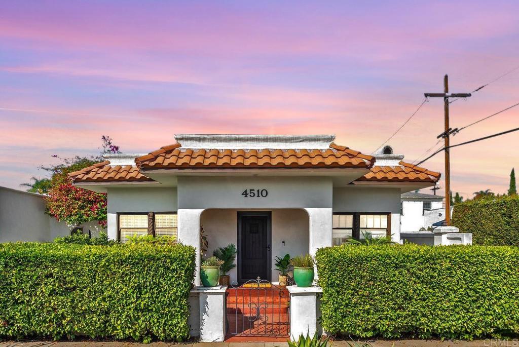 Nestled in the heart of Kensington Village, this exquisitely remodeled 1925 Spanish-style residence at 4510 Marlborough Dr. seamlessly marries timeless elegance with contemporary sophistication. Spanning two generously proportioned bedrooms and two impeccably designed bathrooms, this home radiates historic charm while embracing modern luxury. A mere stroll from Kensington’s vibrant cafes, boutique shops, and verdant parklands, this property offers an unparalleled lifestyle of convenience and refinement. Step inside to a gracious living room adorned with original built-in cabinetry, lustrous bamboo hardwood floors, and a meticulously tiled wood-burning fireplace with an energy-efficient insert, creating a warm yet eco-conscious ambiance. The open-concept kitchen, a culinary masterpiece, showcases opulent leathered granite countertops, a state-of-the-art Viking refrigerator, and a sleek induction range, perfectly poised for sophisticated entertaining. The primary suite is a sanctuary of indulgence, featuring a capacious walk-in closet, a sumptuous en-suite bathroom with refined finishes, and elegant French doors that open to a tranquil backyard retreat. Here, artfully stamped concrete and a graceful pergola create an idyllic setting for al fresco dining or quiet repose. This distinguished residence is further enhanced by a one-car garage, a spacious shed for additional storage, and ample driveway parking. Recent upgrades elevate its appeal, including a pristine newer roof, a high-efficiency HVAC system, refreshed stucco exterior, a robust 200-amp electrical panel, and a modern washer/dryer. Centrally positioned with effortless freeway access, this home offers seamless connectivity to all of San Diego’s cultural and professional hubs, while the charm of Kensington Cafe and the neighborhood’s premier dining and shopping destinations lie just steps away. A rare jewel in Kensington Village, 4510 Marlborough Dr. is an invitation to live with grace and style.