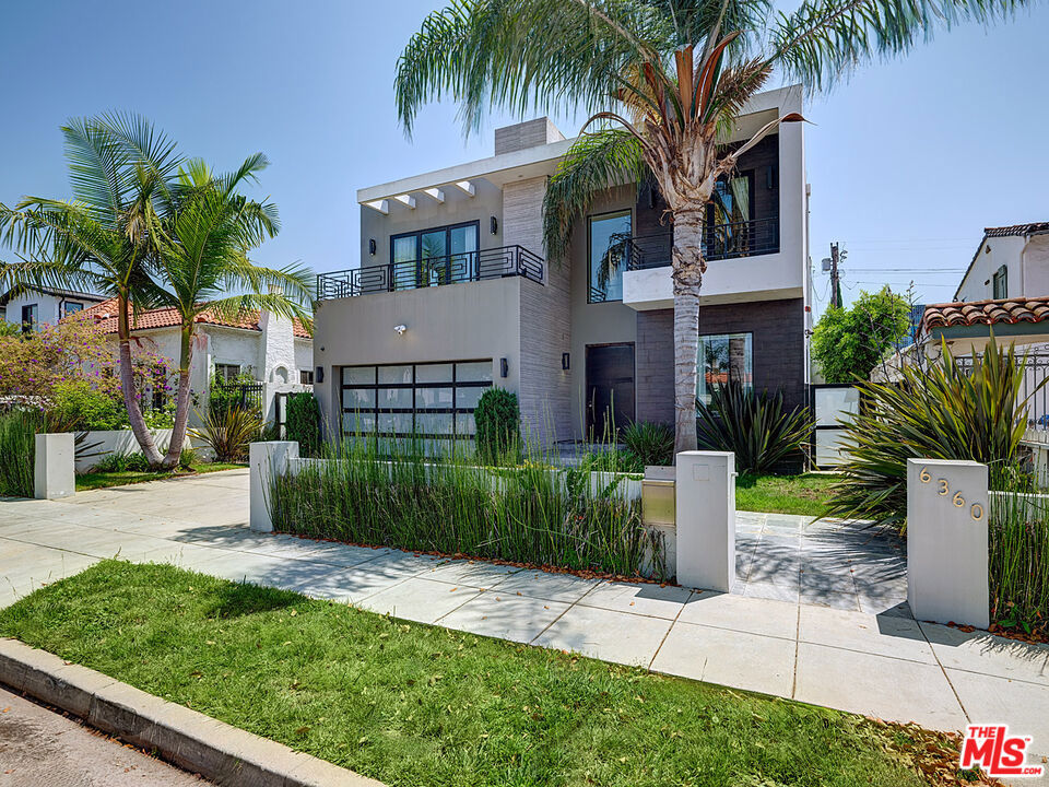 SALE SUBJECT TO BANKRUPTCY COURT APPROVAL AND OVERBID! Nestled on prestigious Maryland Drive where Beverly Hills meets the cultural pulse of Los Angeles, this striking contemporary residence embodies the essence of California modernism. Once home to pop sensation Madison Beer, this 2013-built architectural gem spans nearly 4,000 square feet of meticulously designed living space, offering an unparalleled blend of sophistication and functionality. The home's dramatic entry sets the tone with soaring ceilings and a sculptural floating glass staircase that serves as both functional element and artistic centerpiece. Natural light floods the open-plan interior through floor-to-ceiling retractable glass walls, creating a seamless dialogue between interior refinement and outdoor splendor. The main living area features one of three interior fireplaces, anchoring the space with warmth while maintaining the home's clean, contemporary lines. At the heart of the home, a chef's kitchen adorned with gleaming quartz countertops, custom cabinetry, and professional-grade stainless steel appliances flows effortlessly into the adjacent family room. Here, a second fireplace creates ambiance while bifold glass doors dissolve the boundary between inside and outtransforming the space into an al fresco entertainment paradise that epitomizes Southern California luxury. Ascending the illuminated glass staircase, the master suite unfolds as a private retreat worthy of its celebrity pedigree. A fireplace creates intimate ambiance in the sleeping area, while a private balcony offers peek-a-boo views of the Hollywood Hills and mid-city area. The spa-inspired bathroom features a separate soaking tub and expansive walk-in closet, while the thoughtfully placed upstairs laundry room adds practical luxury to daily life. Each of the five bedrooms boasts an en-suite bathroom and private balcony, fifth bedroom does not have a closet and can be a flex room. The rear yard epitomizes resort-style living with a sparkling pool and spa, complemented by an outdoor kitchen equipped with grill, sink, and stovetop. The fire pit area and expansive patio deck create multiple zones for entertaining under the California stars, all enhanced by a built-in speaker system and Control4 smart home technology. This forward-thinking residence features solar panels and a Tesla charging station in the two-car garage, with additional driveway parking for guests. Every detail has been considered, from the recessed lighting and hardwood floors throughout to the home's Beverly Hills-adjacent location that places residents at the epicenter of Los Angeles culture. A leisurely stroll leads to The Grove's shopping and dining, LACMA's world-class exhibitions, the Beverly Center, and the boutique treasures along 3rd Street and Beverly Boulevard. This Maryland Drive masterpiece represents a rare opportunity to acquire a turn-key modern estate where celebrity glamour meets family functionality in one of LA's most coveted neighborhoods.