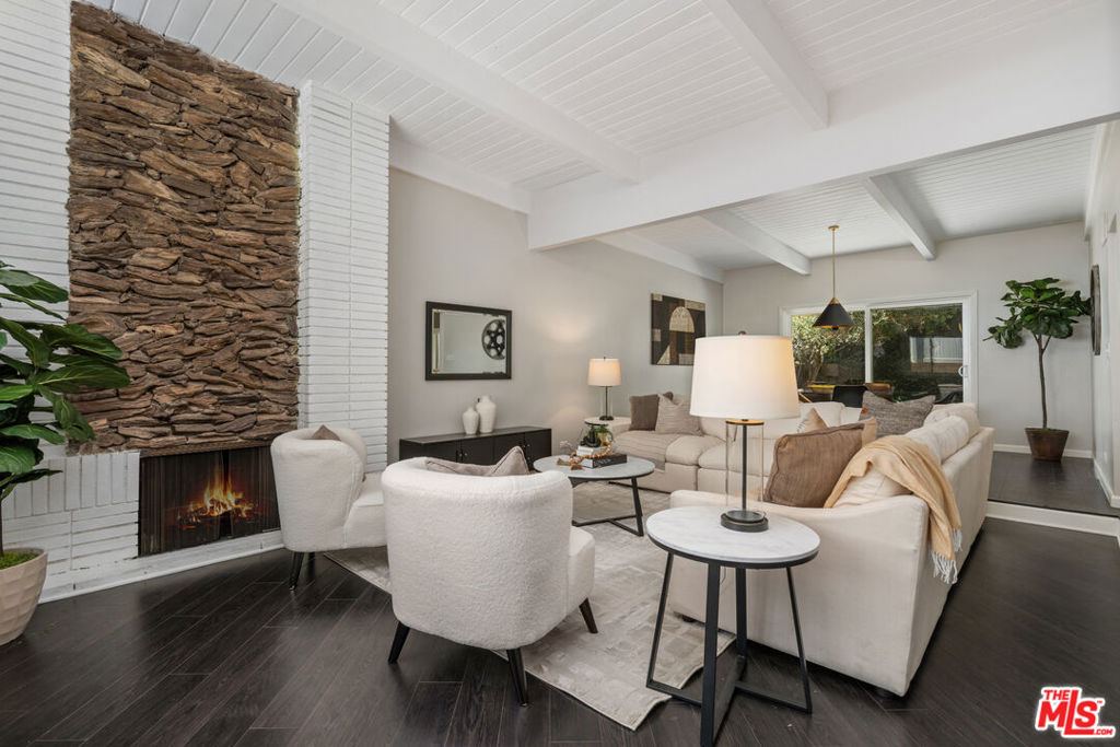Come establish your dream lifestyle in this stunning mid-century modern home, located in one of Chatsworth's most sought after neighborhoods. With 2,355 square feet of thoughtfully designed living space (1,923 Main Home and 432 Fully Permitted ADU), this inviting residence is effortlessly perfect for entertaining your friends and family. As you enter the home, you are welcomed by an open and airy floor plan boasting with natural light. The entertainment spaces features a sleek modern kitchen with waterfall edge counter tops, breakfast bar and bonus space. The entertainment space flows to three comfortable bedrooms, including a primary suite with a generously large walk-in closet. Step out of the third bedroom into a private outdoor entertainment space or head to the lush backyard featuring newly installed grass and beautiful mature lemon tree. The fully permitted ADU has its own private entrance and mailing address, allowing for complete privacy. Whether you're hosting unforgettable gatherings or enjoying peaceful everyday moments, this exceptional property offers the perfect blend of style, comfort, and versatility.