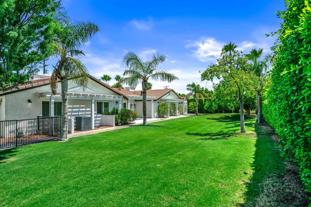 Your own private park in this Mediterranean Mini-Estate surrounded by complete privacy hedges on nearly a 1/2 acre corner site conveniently located with parking for 8+ cars, a private pool and spa yard and a wonderful home of over 3000 SF. Total investment is under $399 per sq makes this home an extreme value way under replacement cost. Living room with views to the mountain view yard and pool area with fireplace, dining area and wet bar. A totally outfitted kitchen with abundant cabinets and a double sized island opens to a family room with a fireplace. The poolside primary suite is very spacious with a fireplace, lovely bathroom with separate walk-in shower and soaking tub and a very large walk-in closet. Two more bedrooms with French Doors opening to the grassy yard and hall bath with dual sinks. The bonus room could be a 4th bedroom and there is also a den or office with bookshelves built. 3 car attached garage with storage plus two detached storage sheds. Travertine floors throughout, separate laundry room and powder bath. The backyard yard features a sparkling saltwater pool, spa with waterfall, large BBQ bar, fire pit and inviting Pavilion for Al Fresco relaxation and dining. The front yard has an amazing real grassy yard with shade trees, fruit trees and swaying palms. Owned solar system covers 90+% of electricity cost if year-round owner. NO HOA. This home can best be described as a private sanctuary.