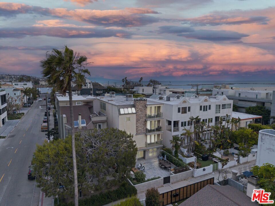 Spectacular main channel and ocean view townhome just seconds away from the sand on a quiet Marina del Rey "walk street". Located in an exclusive two-unit building, this light-filled 3-story contemporary residence offers 3 bedrooms and 3.5 baths, including a loft-style den/office as the third bedroom. Soaring ceilings and abundant natural light elevate the main living area, while the open-concept kitchen set above the living space features Viking appliances, soapstone counters, and maple cabinetry. A private elevator from the lobby opens directly into the main living and dining level. Internal stairs connect to the loft, elevated kitchen, and lower bedroom floors, creating ideal separation for live/work lifestyles and entertaining. The spacious primary suite includes a fireplace, spa tub, dual vanity, and private balcony. The junior suite also enjoys a private spa-style bath and ample closet space. Additional highlights include bamboo flooring, built-in sound system, Phantom screens, generous storage, and two shared guest parking spaces. The cooperative, self-managed HOA emphasizes shared responsibility and collaboration between both unit owners.