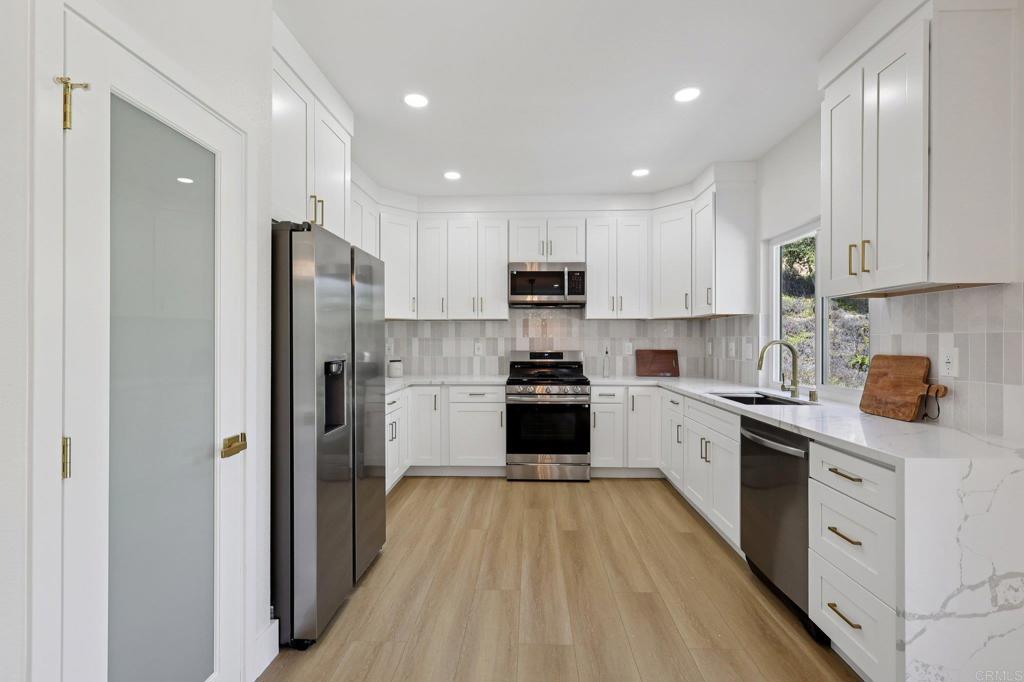 Gorgeous 5-bedroom, 2.5-bathroom home in the highly desirable Wilmont Ranch neighborhood of Oceanside! This beautifully updated residence features a stunning white kitchen with stainless steel appliances, a spacious pantry, and an open layout perfect for modern living. The inviting family room boasts a cozy fireplace, while all bedrooms are located upstairs for added privacy. The spacious primary suite includes a spa-like bathroom with a soaking tub and direct access to a private deck with sweeping neighborhood views. Enjoy a backyard ideal for entertaining, with plenty of space to add a pool or ADU. A rare 3-car garage completes this exceptional property. Don’t miss this opportunity!