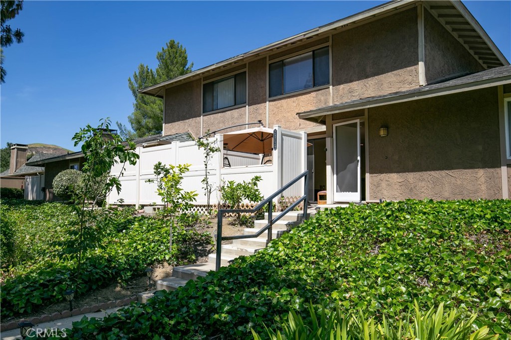 Welcome to this beautifully upgraded townhouse in the heart of Agoura Hills! This bright and airy 2-bedroom, 2-bath home has been tastefully upgraded with modern finishes, featuring laminate flooring, recessed lighting, and a fresh, contemporary color palette throughout. The open-concept living space flows seamlessly to a private patio, perfect for relaxing or entertaining outdoors. A second enclosed patio offers versatile storage for outdoor gear or could be transformed into a cozy retreat. The sleek staircase with modern railings adds a unique architectural touch and complements the home’s stylish vibe. Residents enjoy HOA amenities including water, earthquake insurance, landscaping, and access to a beautiful pool, spa, and clubhouse just steps away. Guest parking is available on the street, and you're within walking distance to Agoura High School, as well as local parks, scenic hiking trails, top-tier dining, shopping, and convenient freeway access. Located in the award-winning Las Virgenes Unified School District, this move-in ready home offers the perfect blend of comfort, convenience, and community.