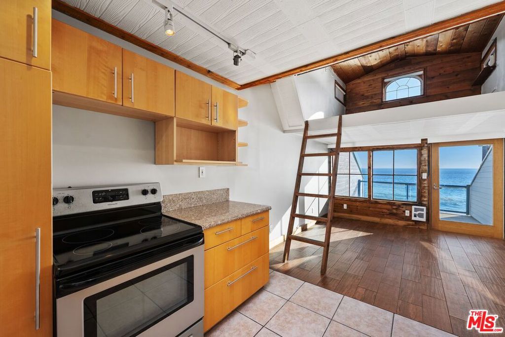 This rare beachfront top studio w/ loft is located on Big Rock beach in east Malibu & features panoramic ocean views from Santa Monica Bay, Catalina Island to Point Dume. It was recently updated w/ new tile flooring, cabinetry, quartz countertops & stainless-steel appliances. The loft features an ocean view window & is spacious enough for a king-size bed. Just below, the open space is perfect for a living/dining area & features a large dual-paned window w/ head on ocean view & direct access to a very private deck. Come soak up the sunshine & enjoy the beachfront lifestyle. It's great as a primary residence, weekend getaway or office. Easy to lock up & is conveniently located just a short 8min drive to Santa Monica. Need more space? Unit #B available as well.