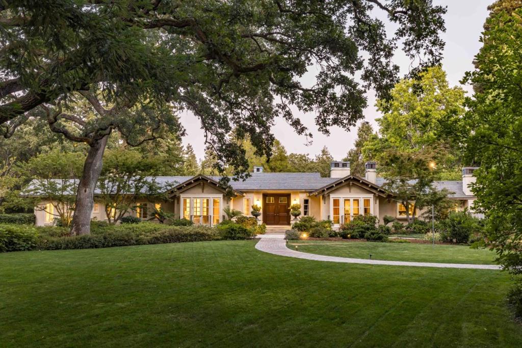 Tucked behind gates on over 2.3 acres, this stunning estate of nearly 7,700 sf offers rare scale, privacy, and resort-like luxury. A long driveway leads to a grand motor court, where towering double doors open to soaring interiors filled with natural light, hardwood floors, and refined stone finishes. The home balances everyday comfort with impressive entertaining space, with expansive gathering areas, a gourmet kitchen, fireplaces, and a private executive office. Four spacious bedrooms anchor the main residence, including a palatial primary suite with a spa-inspired bath. The grounds are equally impressive, featuring sweeping lawns, a spectacular pool, sun-drenched terraces, and multiple areas to relax and entertain. A stylish pool house includes its own guest suite for extended stays, while a separate wine building evokes the charm of a boutique Napa tasting room. This private retreat is minutes from downtown Menlo Park and Palo Alto, Stanford University, and Sand Hill Road.