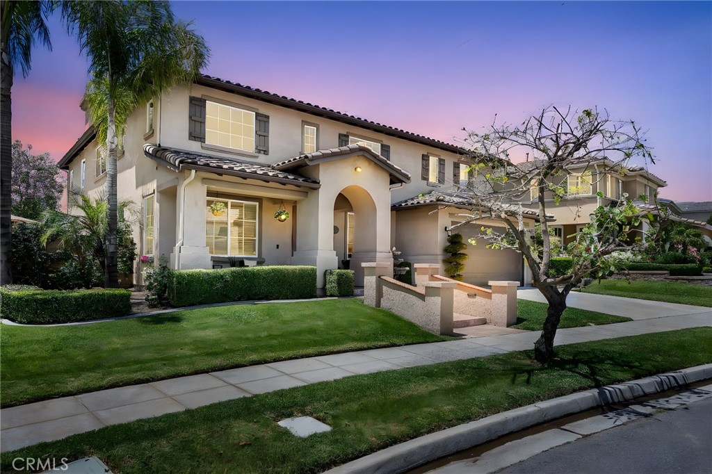 Welcome to this stunning home located in the prestigious Legacy neighborhood of the Colonies in Upland, where upscale living meets timeless elegance. Nestled behind a meticulously manicured landscape that radiates curb appeal, this exquisite residence welcomes you with a grand foyer and soaring vaulted ceilings that immediately evoke a sense of elegance and spaciousness. The home boasts a harmonious neutral color palette throughout, complemented by rich hardwood flooring and an abundance of natural light that floods every room. Thoughtfully designed for both comfort and functionality, it features a desirable downstairs bedroom and full bathroom for guests or multigenerational living. The formal living and dining rooms offer refined spaces for entertaining, while the expansive family room anchored by a cozy fireplace, flows seamlessly into a gourmet kitchen equipped with dual ovens, a five-burner cooktop, a large center island, breakfast bar seating, and an abundance of cabinetry and storage. Upstairs, a built-in office area and spacious loft with serene views of mature trees and the neighborhood offer versatile spaces for work and relaxation. The luxurious owner’s suite is a true retreat, featuring dual walk-in closets, a spa-inspired bathroom with dual sinks, a separate vanity area, a soaking tub, elegant stone accents, a dual-head rain shower, and a private water closet. Step outside to your private backyard oasis, complete with a waterfall pool and adjoining spa accented with stone, a built-in BBQ island with refrigerator, multiple lounging spaces, lush tropical landscaping, low-maintenance turf, and two hardscaped patios one with an extended Alumawood patio cover and dual ceiling fans for year-round comfort. Enjoy privacy and tranquility with mature trees and access to scenic walking trails, designated viewpoints with gazebos, and expansive greenbelts perfect for picnics or family photos. Additional highlights include a dedicated laundry room with cabinets, sink, and counter space, and a finished three-car tandem garage with epoxy flooring. The sophisticated architectural details elevate the home’s aesthetic. This home truly offers the perfect blend of luxury, comfort, and turnkey lifestyle in one of Upland’s most desirable neighborhoods. Enjoy the benefits of low HOA fees, no Mello Roos, and modest property taxes, all just minutes from premier shopping, dining, and top-rated schools.