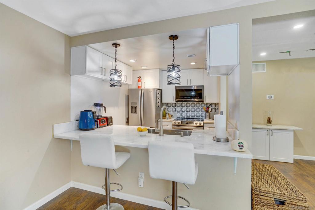 Resort style living! The recent remodel includes a stunning kitchen and appliances, hardwood floors and bathroom upgrades; Ground floor unit with Greenbelt view; Large patio with storage closet; Assigned parking spot in front of unit; Walking distance to Snapdragon Stadium, forthcoming West SDSU Campus, MTS trolley station and eateries; The complex includes a gym, pickleball courts, tennis courts, pools, spas, sauna, dog park, volleyball and basketball court; Try FHA or VA financing;