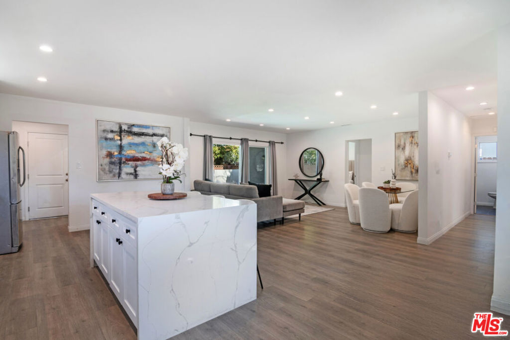 Tucked at the end of a quiet cul-de-sac, this extensively remodeled home offers modern comfort, flexible living, and income potential. The main residence features 3 bedrooms and 3 baths with an open-concept layout, sun-filled living room, and a stunning new kitchen with quartz countertops, custom cabinetry, and a large center island perfect for entertaining. The spacious backyard includes a sparkling pool and spa, ideal for relaxing or hosting. All bathrooms have been stylishly updated. Additional highlights include a generous laundry room, fresh paint, water-resistant laminate flooring, new LED lighting, and a wide driveway. The attached 1-bed/1-bath ADU with full kitchen and living room is now vacant and can be perfect as a guest suite, home office, or excellent income opportunity.