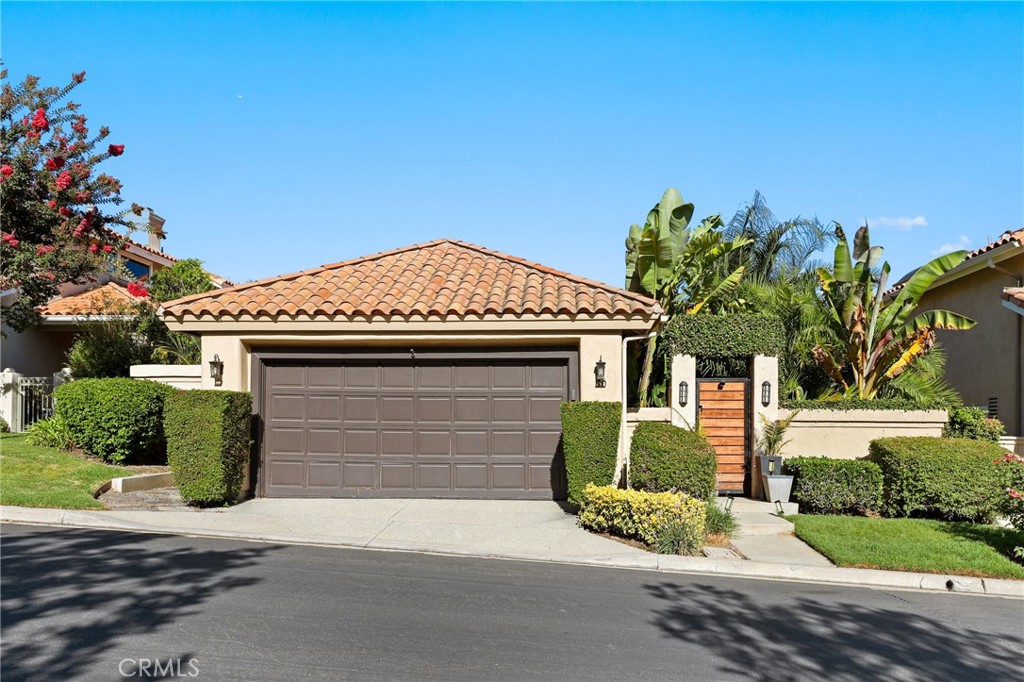 Welcome to 90 Via Candelaria, a truly rare offering in the prestigious gated community of Coto de Caza. One of only 30 single-story ranch-style homes in the entire community, this residence stands out in both exclusivity and design. Ideally located on the northern side of Coto, it is just minutes from the RSM shopping plaza and Coto Sports Park. With no homes in front or behind, the property offers unmatched privacy, serenity, and sweeping 180-degree views of the golf course, lake, Saddleback Mountains, and Caspers Wilderness Park. Evenings are especially magical, with no light pollution and the rare chance to stargaze under open Orange County skies. Inside, the home showcases vaulted ceilings, real hardwood floors, recessed LED lighting, and ceiling fans in every major room. The living area features a custom white tile wall with an electric fireplace, complete with built-in speaker wiring and TV mount. The kitchen is appointed with freshly painted white cabinetry, stainless steel appliances, and new lighting. The primary suite includes sliding doors to the backyard oasis, crown molding, dual sinks, a walk-in shower, and custom lighted bathroom mirrors. Additional enhancements include automated irrigation, custom front gates, upgraded hallway and bathroom lighting, and a pet-friendly backyard fence with a stone path leading directly to the golf course. The highlight of this home is the spectacular backyard, where over $150,000 has been invested in creating a tropical paradise. The landscape features more than 100 palm trees—including 40+ rare species sourced from across California. These palms have been grandfathered in, making this the only property in the Terraces permitted such plantings. Fruit-bearing lemon, orange, lime, and apple trees add to the lush setting. Bamboo fencing, layered palms, and LED flame solar lighting complete the oasis, offering shade by day and ambiance for evening entertaining. Residents of the Terraces enjoy a private pool and spa, while Coto de Caza offers world-class amenities including the Golf & Racquet Club with tennis, pickleball, pools, spas, dining, and fitness center, as well as equestrian facilities, a sports park, and miles of scenic trails. More than a home, 90 Via Candelaria is a rare single-story retreat offering privacy, exclusivity, and natural beauty in the heart of Coto de Caza.
