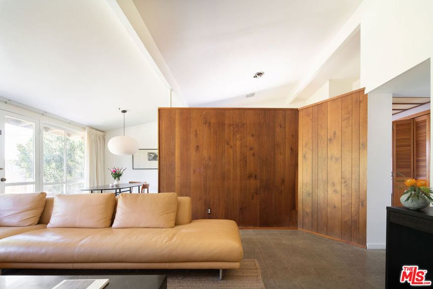 Miraleste Knolls, 1955 - Edward H. Fickett, FAIA. Sited in the rolling hills above San Pedro, this three-bedroom, two-bath residence, designed by architect Edward Fickett, a pioneer of mid-century design, is now available for just the second time in 70 years. This well-preserved example retains all the Fickett hallmarks of the era - his signature open kitchen, angular clerestories, and an open living space grounded by a sculptural fireplace hearth. Many original architectural finishes, such as the walnut cabinetry, wood-paneled walls, and the frosted glass soffit lighting, remain beautifully intact. The living area is flanked by a continuous wall of glass, offering a view of the oversized flat yard with mature trees and an outdoor fireplace. Indoor-outdoor connections in every room create a sense of spaciousness that extends well beyond the home's boundaries, providing ample opportunities to enjoy the nearly 12,000 SF lot and the natural beauty that surrounds it. Edward Fickett became the go-to architect for California residential developers. By 1960, the Los Angeles Times estimated that he had already built more than 40,000 homes. This unspoiled mid-century gem, designed by one of the most prolific architects of the era, is situated on a quiet, tree-lined street, adjacent to the hiking trails and dramatic ocean views of Friendship Park, and located in a close-knit community with excellent schools, restaurants, and other amenities nearby.