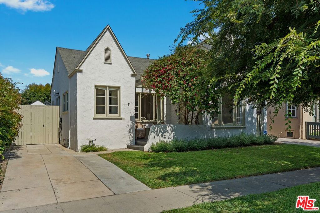 Re-imagined Quaint Country English with Guest House and Grand Rear Yard! Warm classic character is elevated with modern design in this remodeled English home. Located in coveted Picfair Village on a quiet tree-lined street. Home features refinished oak hardwood floors throughout, historical coved ceilings, and gleaming natural light shining through original restored arch casement wood windows. Great charm and character intact throughout this home: Original hall built-in cabinets & the subtle chair rail molding details are just a couple of examples. The kitchen and bathroom tile work are inspired and peaceful. Built-in banquette seating off the kitchen is the perfect casual dining spot for less formal dinners. Turnkey remodeled kitchen with new checkered tile floors, new stainless steel appliances, and new countertops. En-suite primary with french doors and remodeled bathroom with tub. Wonderful indoor/outdoor flow throughout the home. Deep grand backyard, with great shade trees and privacy hedges. On the exterior, you'll find three porches, usable driveway, manicured grassy lawns, and 3 covered pergola spaces, all of which make it a great space for entertaining (but most importantly: daily inspired living!). Walking past the rose garden, you'll find the rear guest unit: A versatile flex space that can function as an office, gym, bedroom, recreation room, or guest suite. High vaulted ceilings and multiple skylights makes the guest house feel larger than sq footage reflects, and the dual-paned windows and sliding doors allow ample natural light to flow. Located in the heart of Picfair, just 2 short blocks to all the dining and shopping on Pico Blvd (think Bloom Cafe, Paper or Plastik, etc). Close to everything in all directions! Welcome home! We look forward to your visit.