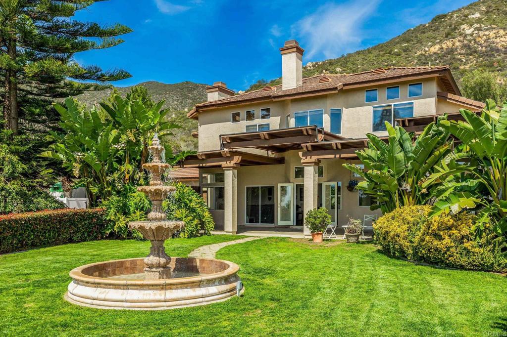 Sweeping coastal views and space to create your dream lifestyle. Nestled on 4.3 acres in Hidden Trails, this private modern retreat offers room to breathe and views that stretch endlessly to the horizon. With open space behind the property, you’ll enjoy unmatched privacy and a setting designed for peace and connection. Inside, 5 bedrooms plus a large flex room and 3 baths provide comfort for every lifestyle. Two downstairs bedrooms make multi-generational living easy, while the expansive primary suite features a fireplace and spa-like bath with a brand-new walk-in shower. The home is filled with light and thoughtful updates, from fresh flooring to a bright kitchen and two inviting living areas with a wet bar for gatherings. Step outside to resort-style living with a Pebble Tec pool and spa, outdoor kitchen, and lush landscaping accented by a tranquil fountain. The owned solar, new HVAC, and newer roof ensure modern efficiency, while the large lower lot offers endless potential, ideal for an ADU, workshop, RV storage, or more. With no HOA and only minutes from Rancho San Diego, this property blends luxury, land, and breathtaking views into one rare find.