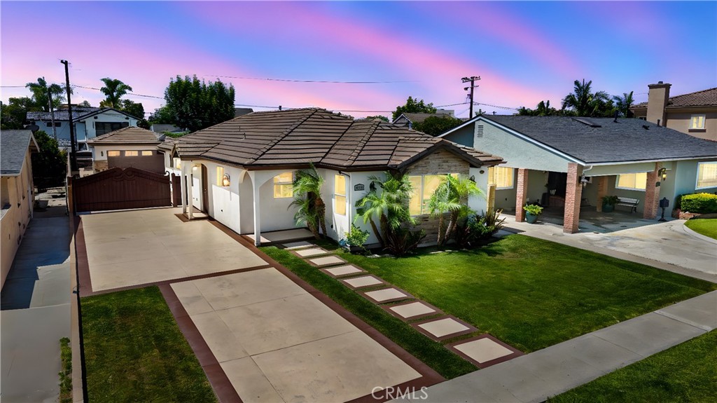 Welcome to this stunning single-story home nestled in a sought-after Northeast Downey neighborhood. Built in 2014, this meticulously maintained residence offers a perfect blend of modern upgrades and charm.
Step inside to discover an open floor plan with 9-foot ceilings, luxurious shutters on all windows, recessed lighting throughout, and elegant waterproof laminate flooring. The beautifully remodeled kitchen is a dream—boasting white shaker cabinets, quartz countertops, stylish tile backsplash, island with seating, walk-in pantry, and stainless steel appliances. The kitchen seamlessly flows into the living and family rooms, creating an ideal space for entertaining and everyday living.
The master suite is a true retreat, complete with a large walk-in closet and a luxurious ensuite bathroom offering a spacious walk-in shower, separate soaking tub, and dual sink vanity. The second bathroom is well-sized, has a walk-in shower, separate tub, dual sink vanity, and a linen closet. Both bathrooms have been remodeled with sleek porcelain tiles and vanities with shaker cabinets and quartz countertops.
Step outside to your private backyard oasis featuring modern pavers and a sparkling pool with rock slide—perfect for warm California days.
Located just minutes from top-rated schools, premier shopping centers, dining, parks, golf courses, and major freeways, this move-in ready home offers convenience and lifestyle in one exceptional package.
Don’t miss the opportunity to make this exquisite home yours!