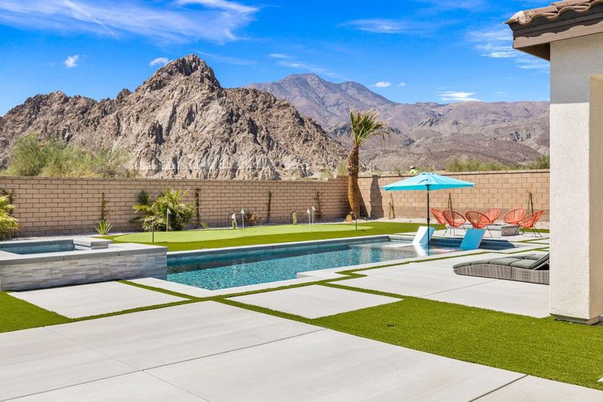 Better Than New! This never-lived-in home is perfectly situated in a premier South La Quinta location with stunning south-facing mountain views. Nestled at the foot of Coral Mountain, this desirable community of single-family homes is just minutes from PGA West Golf Course and a short drive to charming Old Town La Quinta. Step inside to an open-concept floor plan featuring a light and bright kitchen with white cabinetry, a spacious pantry, and a seamless flow into the great room -- perfect for entertaining. Offering 4 generously sized bedrooms, including a private primary suite with a direct door to the backyard. The newly completed backyard is an entertainer's dream, featuring a Pebble Tec pool & spa, putting green, gas firepit, plumbed BBQ, and a smart pool system for easy control. Additional highlights include upgraded flooring throughout, a tandem 3-car garage, low taxes, and low HOA fees. Don't miss the opportunity to own this stunning South La Quinta retreat!