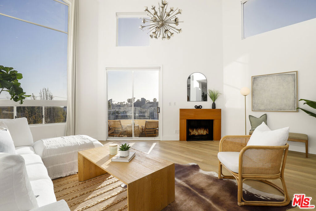 Penthouse Living by the Sea | 2 Bed + Loft | Ocean Views | Prime Venice Location. Welcome to this sophisticated penthouse residence just one block from the beach, nestled in the heart of Venice. This rare corner unit offers 2 bedrooms, 2 bathrooms, plus a versatile loft space perfect for a home office or guest retreat. Completely renovated with brand new engineered luxury vinyl plank flooring, this light-filled home boasts vaulted cathedral ceilings, expansive floor-to-ceiling windows, and an open-concept layout that seamlessly blends comfort and style. The living room fireplace, recessed lighting, and private balcony with ocean views create an inviting space to unwind or entertain. The chef's kitchen features quartz countertops, white shaker soft-close cabinetry, stainless steel appliances, a convection oven, breakfast bar, and a dedicated formal dining area all designed for effortless entertaining. The spacious primary suite offers a walk-in closet and a luxurious en suite bath with dual vanities and a jacuzzi tub. A second full bath, Miele washer/dryer and central HVAC complete the interior. Upstairs, your own private rooftop deck showcases panoramic ocean views, a true sanctuary above the city. Residents enjoy access to resort-style amenities, including a pool, spa, two side-by-side parking spaces, plenty of guest parking, and a private storage unit. Unbeatable location just moments from Abbot Kinney, Rose Ave, and Main Street's shops and restaurants. Coastal elegance and urban convenience converge in this truly exceptional home.