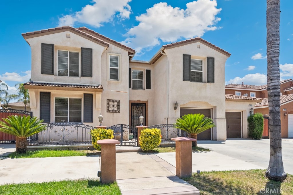 Spacious and functional, this beautifully designed home features a gated front patio entrance and a main-level junior suite with a walk-in closet and full bath—ideal for guests or multi-gen living. The kitchen is a chef’s dream with granite counters and backsplash, a large center island, butler’s pantry, and walk-in pantry. Formal living and dining rooms provide elegant entertaining space, while the family room offers a cozy fireplace and built-in entertainment center. A slider opens to a backyard retreat with a covered patio with ceiling fans, built-in BBQ island, and expansive grassy area. Upstairs includes a loft, 4 additional bedrooms, and 2 bathrooms, including a huge primary suite with dual walk-in closets and a luxurious en suite bath with soaking tub, dual vanities, and separate shower. A 3-car tandem garage offers ample parking. Owned solar system offers energy efficiency and savings. Conveniently located near markets, schools, and dining options.