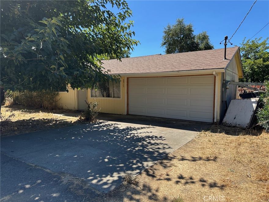 3 Bedroom 1 1/4 Bath home with adjacent lot included. Brand new mini split heat and air monitor heater needs sensor Home has newer roof and garage door.  Flooring in kitchen is vinyl, living room and bedrooms are laminate. Main bathroom has tile flooring and shower over tub. Larger back yard with covered patio off house. Storage sheds in back yard