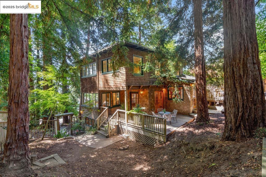 Shaded by mature redwoods, this Berkeley Hills hideaway provides the epitome of privacy minutes from parks, grocers and eateries. Exhibiting a treehouse-like quality, the shingled stunner features cozy, Craftsman-style interior that retains period charm while embracing modern-day conveniences. Illuminated skylights, a quaint kitchen with cozy breakfast nook features a bank of windows that welcome morning light. A great room is the heart of the home, beautifully blending a fireplace-clad living room and solarium-like dining room. Upstairs, a pair of light-soaked bedrooms are joined by an expansive sunroom framed by lush greenery. Those in the primary suite enjoy a marble vanity, W/I closet, and adjoining bath with pedestal sink and claw-footed tub. The lower level is perfect for housing guests, replete with a spacious bedroom, sitting area, full bath, and laundry. A storybook property ensconced in towering trees, this Berkeley Hills haven features a detached garage with sunny cottage. Open Sunday 9/14 and 9/21 2-4:30pm. Views: Downtown