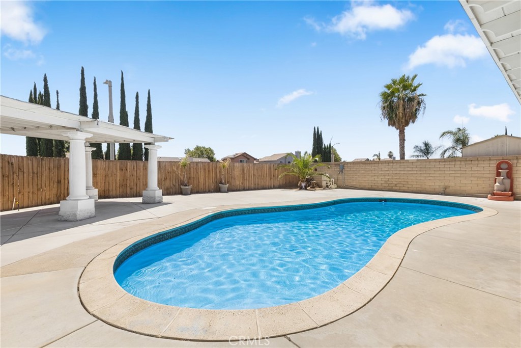 Gorgeous Pool Home with RV Parking in the Heart of Moreno Valley! Pool homes in Moreno Valley are rare—and they don’t last long! This beautifully updated 4-bedroom, 2-bathroom home offers 1,434 sq. ft. of living space on a spacious 7,405 sq. ft. lot. Step into a bright and airy living room featuring vaulted ceilings, hardwood floors, and abundant natural light. The open dining area flows into a stylishly upgraded kitchen complete with custom cabinets, sleek countertops, stainless steel appliances, recessed lighting, and a picture-perfect view of the backyard and sparkling pool. Downstairs, you’ll find one bedroom and a full bath—ideal for guests or multi-generational living. Upstairs features three additional bedrooms and a large shared bathroom. Throughout the home, enjoy updated flooring, modern light fixtures, and ceiling fans for added comfort. The backyard is made for entertaining! Enjoy a low-maintenance hardscaped yard with a large swimming pool, a spacious covered patio, and a charming gazebo—perfect for summer BBQs or relaxing poolside. Bonus features include PAID-OFF solar, extra-large RV parking, and ample driveway space. Centrally located near schools, shopping, and freeway access, this home truly checks all the boxes. Don’t miss this incredible opportunity—pool homes like this go fast!
