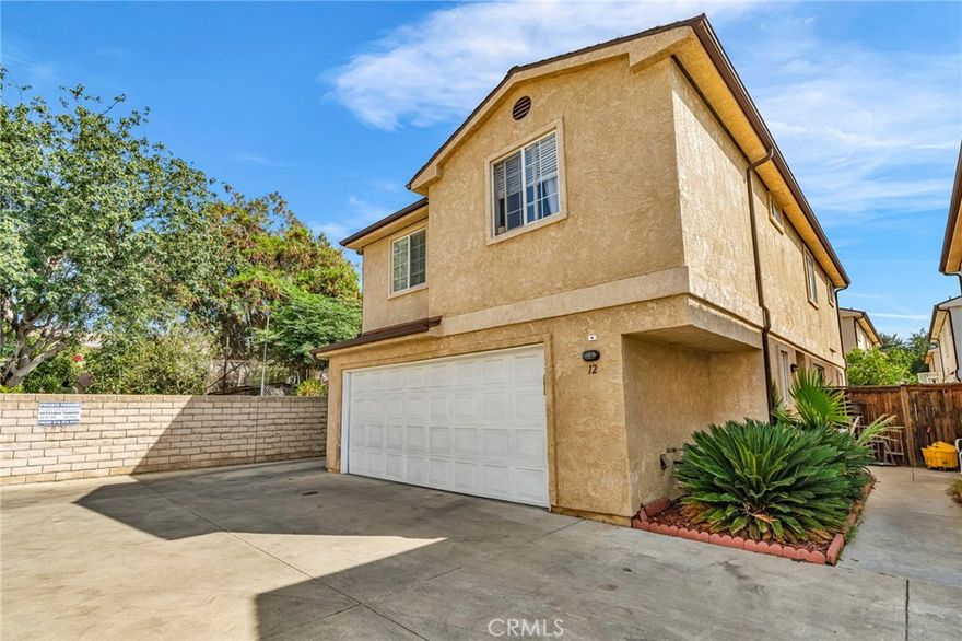 Elegant and beautifully, this expansive townhome offers 4 spacious bedrooms and 3 full bathrooms. The refined interior features a living room, a family room, an updated kitchen, and a separate formal dining room that can also serve as a home office or additional bedroom. A charming fireplace creates a warm and inviting ambiance, perfect for relaxing or entertaining. The property includes a 2-car garage plus an additional parking space, providing ample parking. Enjoy the townhomes large back and side yard — ideal for stylish outdoor gatherings, serene lounging, or lush landscaping. A truly exceptional residence that combines space, comfort, and elegance.