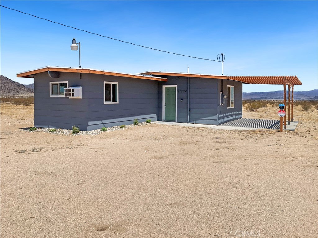 Welcome to your serene escape in the heart of Landers, where privacy meets panoramic beauty on 5 expansive acres of high desert landscape. This 1-bedroom, 1-bathroom SINGLE FAMILY RESIDENCE offers stunning 360-degree mountain views, making it a true retreat for those seeking peace, natural beauty, and proximity to local attractions. Step inside to find a modern, open-concept kitchen featuring brand-new stainless-steel appliances, perfect for both everyday living and entertaining. The glass sliding door seamlessly connects indoor and outdoor living, opening up to a spacious porch ideal for sunrise coffees or stargazing under the desert sky. Comfort is key, with a mini-spilt air conditioning and heating system, plus an additional bedroom wall unit, that heats AND cools to keep the home perfectly climate- controlled year-round. A stackable washer and dryer add to the home's functionality, while an alarm system ensures peace of mind. Forget about water bills because this retreat features a 2,500-gallon tank with an additional 500-gallon underground reserve tank. Reliable local water delivery makes it simple, and more affordable than drilling a well. Enjoy the ultimate privacy while still being close to local hot spots, including the iconic Giant Rock and the unique Giant Rock Meeting Room venue. Whether you're looking for a peaceful full-time residence, a weekend getaway, or an investment in the growing Landers area, this home is a rare find.