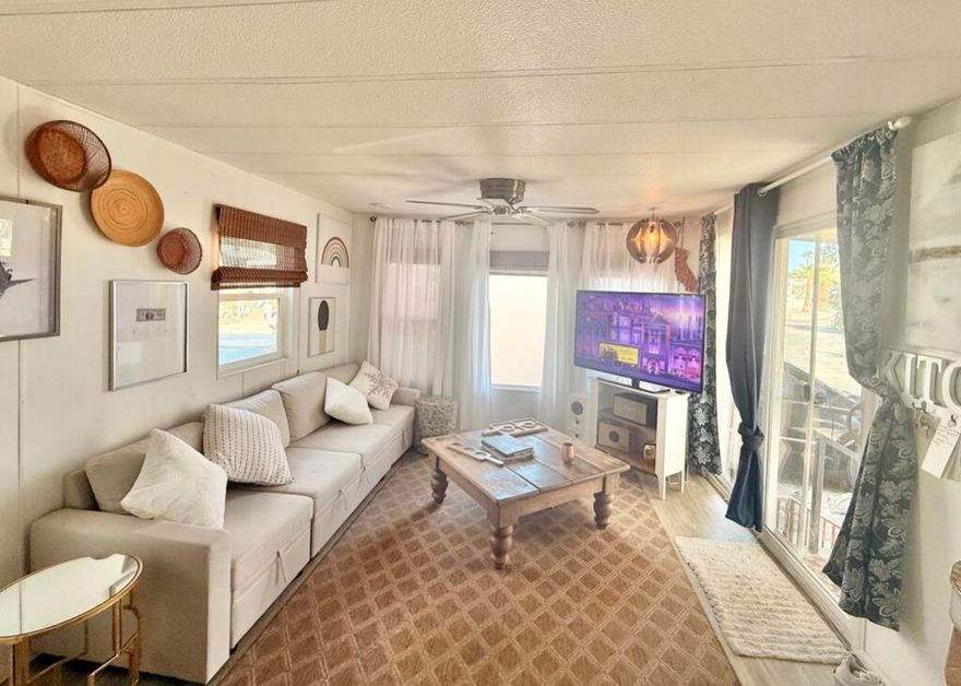 Charming open concept park model with covered carport and large yard overlooking the Wild West Wash known for its beautiful San Jacinto mountain view of colorful sunsets.  Gated community in an ALL AGED PARK with greenbelts, ponds, 13 hot spring mineral pools, pickleball, tennis, walking trails, cafe, chef, fitness center, library, and more!  High season brings lots of activities and social events including free concerts.