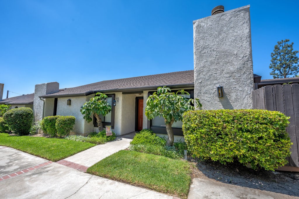 This beautifully reimagined single-level townhouse showcases high-end finishes and a true sense of pride of ownership. Offering 3 bedrooms, 2 bathrooms, and approximately 1,403 square feet of living space, this residence is located in one of Sierra Madre’s most desirable single-story complexes. The living and dining areas feature soaring ceilings, abundant natural light, warm engineered wood flooring, and a welcoming fireplace, making this the true heart of the home. The chef’s kitchen is a standout, with ample counter space, abundant cabinetry, Caesarstone countertops, a custom tile backsplash, and high-end stainless-steel appliances. A well-placed sink window overlooks the private yard, filling the space with light, while the inviting breakfast area is enhanced by a custom-built walnut hutch that adds both warmth and functional storage.
The primary bedroom suite is spacious and airy, with high ceilings that enhance its open feel. It includes a walk-in closet, a dual-sink vanity, and a separate shower/toilet room. Best of all, the suite offers direct access to the private rear yard, creating a seamless indoor-outdoor retreat.
The hall bath has been beautifully updated with a marble countertop and shower tiles, creating a sleek and tastefully designed finish that feels both timeless and modern. Additional highlights include recessed lighting, mirrored closet doors, a newer water heater, custom window treatments, laundry and a private 2-car garage. Situated on a quiet residential street, this townhouse is within walking distance to the local park, shops, and restaurants. HOA covers water, landscaping, and trash.