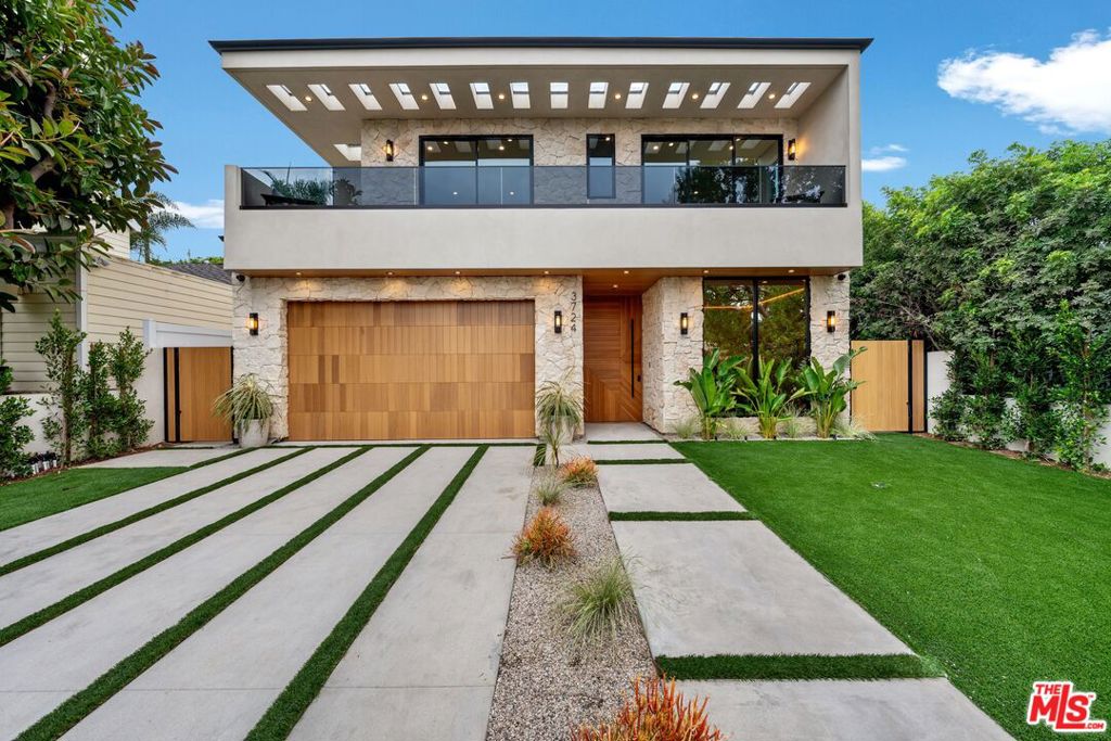 Truly an exceptional one-of-a-kind new construction with no expense spared; creating a custom home that checks all the boxes for design and comfort. Featuring 5 bedrooms and 5.5 bathrooms, this modern style residence showcases state-of-the-art finishes and a flowing open floor plan filled with natural light. Highlights include a striking floating staircase, engineered hardwood floors, and elegant details throughout. The gourmet kitchen is a showstopper with rustic oak cabinetry, Taj Mahal quartzite counters, and seamless connection to the dining and living areas. The primary suite features a private balcony and a custom walk-in closet, combining luxury with function, and includes an en suite bath with a fabulous oversized shower and freestanding tub. As a caveat for entertaining, the home includes a theatre room, expansive living and dining spaces, and a backyard oasis with a pool, spa, and landscaped grounds. The electric front gate and full fencing ensure privacy and security. This home embodies modern elegance with thoughtful craftsmanship at every turn; a rare offering in the heart of Mar Vista.