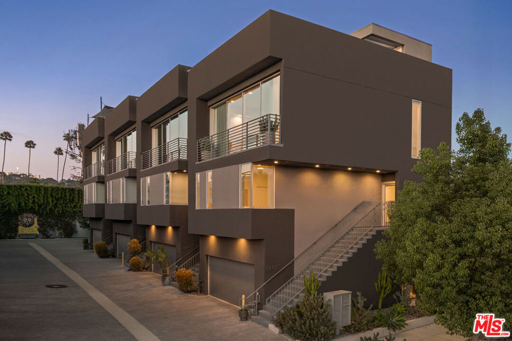 In the heart of Atwater Village, this modern four-level home by Corsini Stark Architects is a smart live/work setup with panoramic rooftop views and a prime location. A ground-level suite with a private entrance is perfect for an office, studio, or guest room, with its own bath and poured concrete floors. The upper level features an open great room with floor-to-ceiling glass, a breezy balcony, and engineered wood floors; the kitchen is a design showcase with quartz countertops, Bertazzoni appliances, and Kohler fixtures. Two bedrooms on the second level include a bright and spacious ensuite primary. The private rooftop deck is a dreamy setting for alfresco dining while enjoying the views over Griffith Park. Amenities include zoned heating and cooling, in-unit laundry, EV charger, finished two-car garage, and extra storage. Just blocks away: Proof Bakery, Dune, Morihiro, Spina, Holy Basil, and Hail Mary Pizza, plus a vibrant mix of independent shops, salons, and local markets.