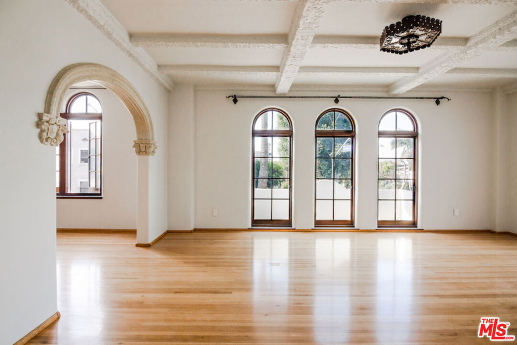 After nearly a century standing proudly in the heart of West Hollywood, the breathtaking El Mirador Apartments reopens its doors. Reborn, refined, and ready to welcome a new generation of residents. Following more than a decade of meticulous and sensitive restoration, this architectural jewel is a prime example of Churrigueresque Spanish Colonial Revival design and has been returned to its original splendor. Built in 1929 by renowned theater architect S. Charles Lee, it stands as a remarkable tribute to its era. Original floorboards were carefully lifted, revarnished, and placed back with reverence. Decades of paint and primer were patiently removed from hand-carved archways to reveal the craftsmanship beneath. Custom-imported rugs now line the grand corridors. Every salvageable element of the building's storied past has been preserved, fought for in some cases, with an unrelenting commitment to authenticity. In El Mirador, the devil is not just in the details. It is in the devotion. Inside each residence, modern comforts blend seamlessly with historic charm. Kitchens feature state-of-the-art appliances set in sleek marble surrounds. Discreet cabinetry conceals in-unit washers and dryers, while retractable screens disappear into window casings to preserve uninterrupted views. Modern comforts seamlessly blend with historic charm.