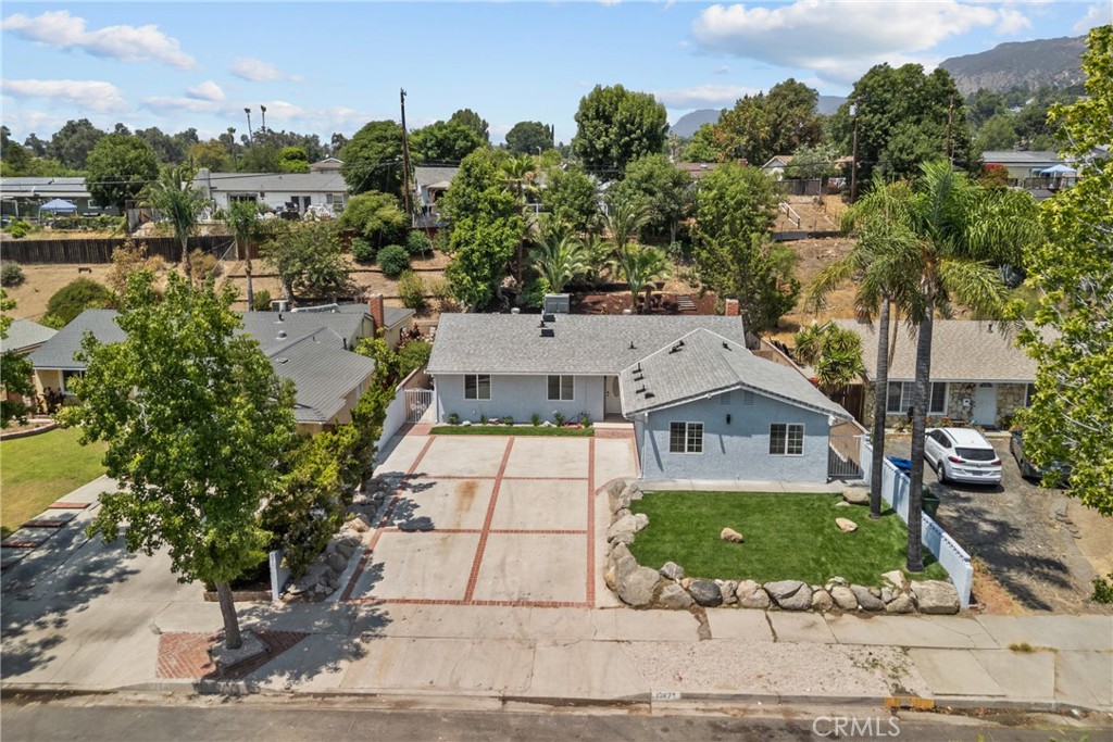 12679 Lazard St in Sylmar is a beautifully remodeled home featuring 4 bedrooms and 2 bathrooms in the main house, along with a brand-new 1-bedroom, 1-bathroom ADU—perfect for extended family, guests, or rental income. The property also boasts a sparkling pool, creating the ideal setting for relaxation and entertaining. Nestled in a peaceful hillside neighborhood, it offers serene mountain views while being just minutes from El Cariso Park, Mission College, golf courses, and scenic hiking trails. Residents enjoy a strong sense of community, access to well-regarded schools, and convenient freeway connections for an easy commute, making this Sylmar gem a perfect blend of comfort, style, and smart investment potential.