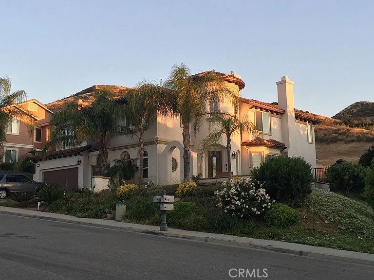 Stunning view home located in the highly sought-after Hidden Ranch community in Simi Valley. This spacious residence offers 5 bedrooms, 4.5 bathrooms, 3-car garage, and a versatile floor plan with expansive loft spaces and multiple living areas.
The main level features a bedroom with attached bath, ideal for guests or extended family, along with separate formal living and dining rooms and an impressive rotunda entry. The kitchen opens seamlessly to the family room and provides direct access to the backyard, creating a perfect space for everyday living and entertaining.
Using the double entry staircase to go upstairs, you will find the expansive primary suite which includes a private balcony with mountain views, fireplace, spa-like bath with separate tub and walk-in shower, and a generous walk-in closet. Furthermore, you’ll also find three secondary bedrooms—one with its own balcony showcasing mountain and valley views, and another with an en-suite bath.
A highlight of the second floor is the spacious loft, divided into three sections, including one positioned above the rotunda with breathtaking views. The loft areas provide flexible space that can serve as a theater, playroom, game room, office, or more.
The backyard features a covered patio and low-maintenance landscaping, perfect for outdoor dining and entertaining. The lease includes refrigerator, washer, dryer, and outdoor grill for added convenience. Ideally located, the home is just a short drive to local schools, restaurants, and shops, as well as the 118 Freeway, providing seamless access to the greater Los Angeles area.
An additional bonus from the front of the home, residents can enjoy views of fireworks displays from Rancho Santa Susana Community Park during 4th of July and other community celebrations.
The interior is being professionally painted throughout, and the main living areas downstairs are receiving new wood-like luxury plank flooring, offering a fresh and modern feel.
Come take a look today and judge this beauty for yourself!