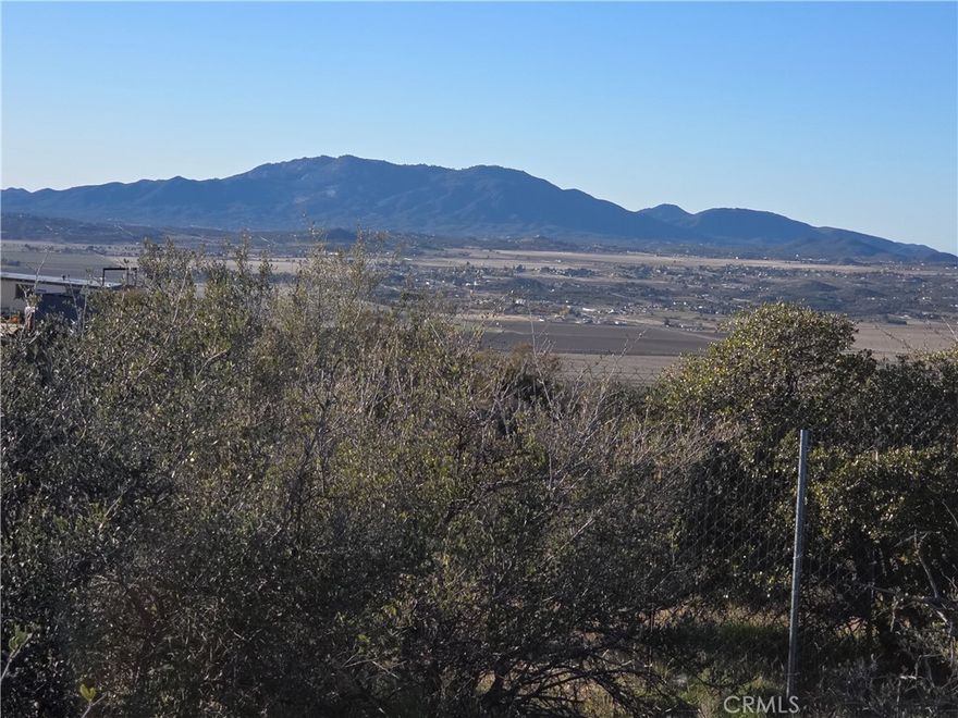 This beautiful parcel has WATER and VIEWS. Fenced and gated with plenty of paths through the native vegetation, this lot is mostly usable with a cleared pad. Check out the views of Mt San Jacinto, Cahuilla Mountain, and Anza Valley! Private water well with Well Completion Report on file. The well was drilled in 2016 and estimated at 25 gallons per minute. Several storage sheds are included. Electricity is at neighboring properties on either side. Owner may carry! Lender info and well completion report are in supplements.