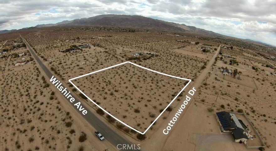 Discover just over 2 acres of untouched desert land on the serene outskirts of 29 Palms. This expansive parcel delivers stunning panoramic views of the southern mountain range and sits only moments from the east entrance of Joshua Tree National Park—perfect for nature lovers, stargazers, and adventure-seekers. Enjoy the quiet, open feel of the high desert without sacrificing convenience. You’ll be tucked far enough away to savor the peace and privacy 29 Palms is known for, yet still just a quick 5-minute drive to local shopping, dining, and essentials. It’s truly the best of both worlds: room to breathe, explore, and build your vision—while staying close to town amenities. Whether you’re dreaming of a desert getaway, an investment property, or a future home site, this lot is a rare opportunity to own a piece of the magic that makes 29 Palms so unique. All lot lines in photos are approximates. Address fictitious to assist in locating property more accurately. Buyer to verify access to all utilities through due diligence.
