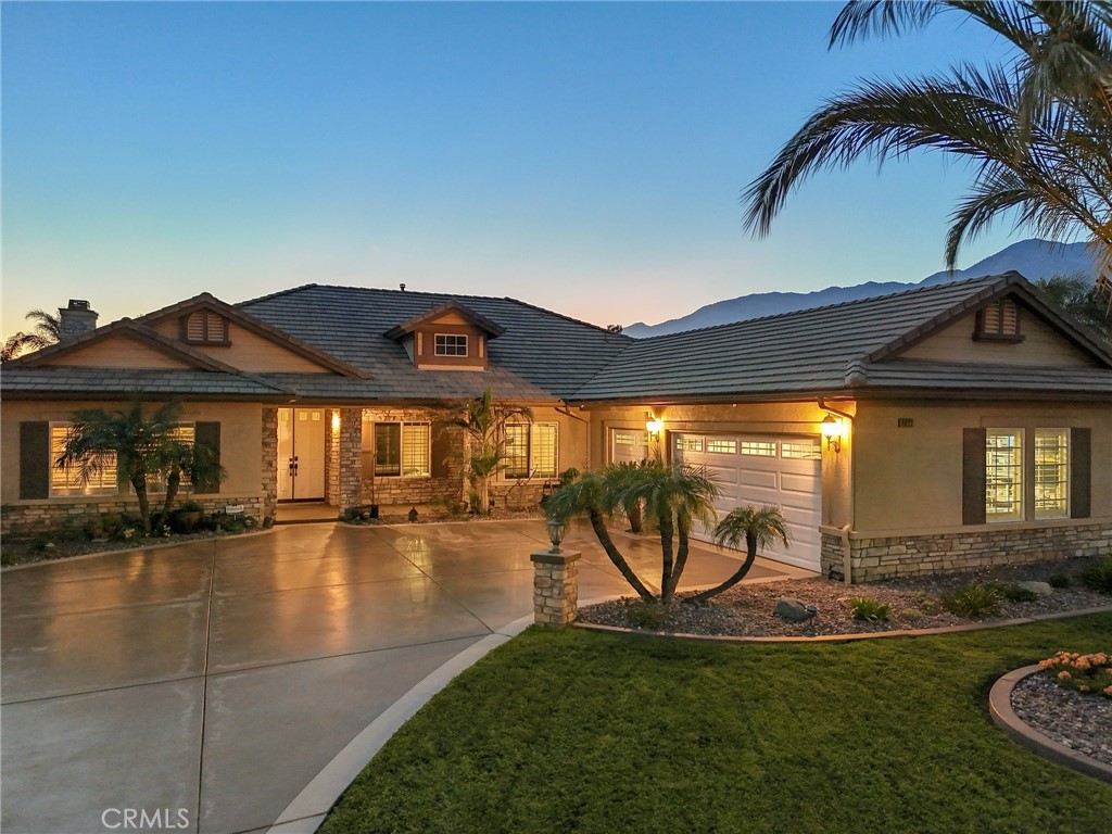 This stunning single-story estate in the prestigious Etiwanda School District offers an unmatched blend of luxury, functionality, and entertainment.
Step inside to an elegantly designed open floor plan, featuring 4 spacious bedrooms plus an office, and 3 bathrooms. The heart of the home is the chef’s kitchen, showcasing granite countertops, a large island with seating, stainless steel appliances, double ovens, and an oversized walk-in pantry. Adjacent, a generous dining area provides the perfect space for family gatherings. Escape to your private primary suite, complete with a spa-like ensuite featuring a soaking tub, walk-in shower, and an oversized walk-in closet. Step outside to your private patio with direct access to the pool area for ultimate relaxation.Outside, experie nce your own tropical resort! The pebble-tech finished saltwater pool and jacuzzi are surrounded by lush tropical landscaping, enhanced by Malibu lighting for a breathtaking nighttime ambiance. An elevated patio and built-in BBQ area overlook the rock pool, creating the perfect atmosphere for entertaining guests. For car enthusiasts, this home is truly one of a kind! The expansive car collector’s garage provides space for 10+ vehicles, in addition to a 3-car garage attached to the main house. Need even more space? A 55’ x 24’ RV garage offers incredible versatility and is fully plumbed with a half bath, water heater, ample lighting, and epoxy flooring—ready to be transformed into a spacious in-law quarters or guest house (approx. 2,800 sq. ft.). An enormous second driveway leads to the detached garage, offering additional outdoor parking for 15 vehicles, plus space on the side of the home for another 5 cars—perfect for hosting events or accommodating a serious car collection. Located in the heart of Rancho Cucamonga, just minutes from Victoria Gardens Mall, top-rated schools, and major freeways, this extraordinary home offers the perfect balance of luxury, privacy, and convenience. Don’t miss out on this rare opportunity—schedule your private tour today!