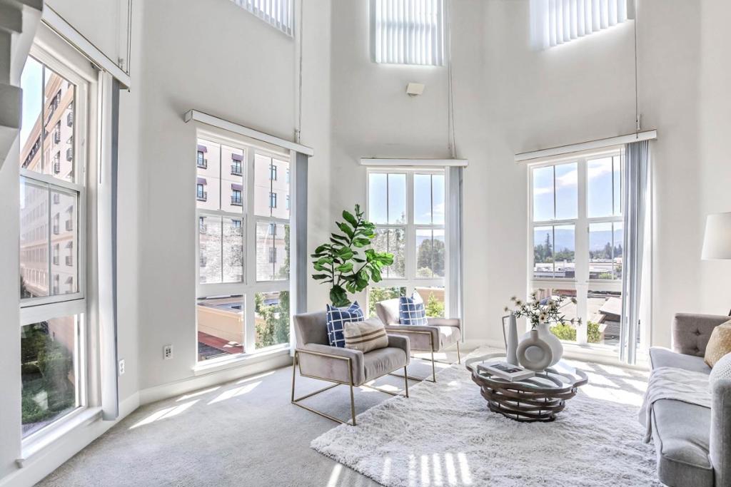 Stunning Corner Unit in the Heart of Cupertino, Top Schools & Soaring Ceilings! Just minutes from Apple Infinite Loop & Apple Campus, Cupertino Library, Cupertino City Hall, Civic Center & Cupertino Main Street. Zoned for Top Cupertino schools: C.B Eaton Elementary, Sam H. Lawson Middle, & Cupertino High. Two-story high living room ceiling, floor-to-ceiling vertical windows, & ceiling-high built-in ledge, vertical blinds & a Three-sided fireplace. The tile entryway leads to plush carpeted flooring throughout. The kitchen has with stainless steel Thermador appliances, granite countertops, a raised breakfast bar, & white cabinetry, & a formal dining area with balcony access. The expansive primary bedroom features a large organized closet & direct balcony access. The ensuite bathroom offers a floating double-sink vanity, bidet toilet, a shower enclosure, & a large mirror with upgraded light fixtures. Additional bedrooms is generously sized with large closets, and the hall bath includes a tub/shower combo and oversized vanity mirror. Convenient in-unit laundry, central location near dining, shopping, and top-tier schools, & quick access to Hwy 280 & Lawrence Expy make this an exceptional opportunity for anyone looking to live in the heart of Silicon Valley.