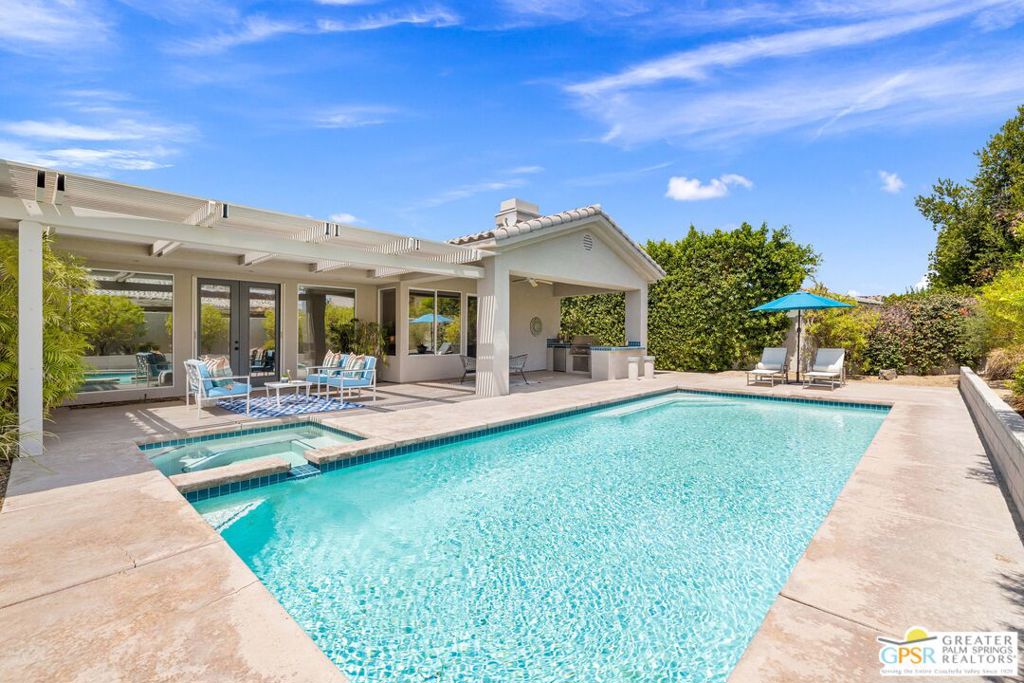 Wow! Set on a desirable corner lot in gated Victoria Falls, this Rancho Mirage home blends comfort, style, and over 3,000 square feet of living space. A gated front courtyard welcomes you inside, where vaulted ceilings in the foyer set the tone for light-filled interiors. French doors swing open from the main living areas, creating seamless indoor-outdoor flow. Both formal and informal spaces are here to enjoy, with a fireplace and wet bar anchoring the living room and a second fireplace warming the family room. The gourmet kitchen features a large walk-in pantry, center island, and plenty of storage. The ensuite primary retreat enjoys great separation from guest bedrooms and opens directly to the patio. The spa-like bath includes a separate tub and shower along with direct pool access, and the suite is finished with a generous walk-in closet. The guest wing offers three bedrooms and a full bath. The hallway itself opens to the front courtyard for added light and access, and a utility room with sink and direct side yard access is also positioned off this wing for everyday convenience. Outdoors, the ultra-private backyard showcases a pool and spa, a pergola-covered patio, and a built-in barbecue with counter seating, perfect for entertaining against a backdrop of mountain views. A spacious three-car garage provides ample room for vehicles, storage, or even a golf cart. Community tennis, pickleball, and basketball courts are just a short hop away. Fee land means you own it, and low HOA dues keep ownership easy.