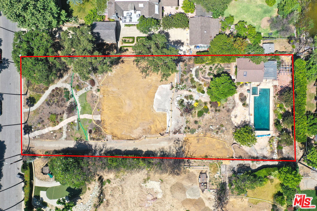 Discover a rare opportunity to own a remarkable piece of land in the coveted Country Club neighborhood of Altadena. This flat lot offers 26,275 square feet of prime residential space, ready for you to rebuild the previous residence or create your dream luxury home.The rear portion of the lot remains perfectly intact, featuring a stunning hardscape, mature landscaping, a sparkling swimming pool, and a beautiful guest house. The guest house includes an outdoor kitchen, a loft, and an elegant bathroom with a tiled shower.Enjoy unmatched privacy and sweeping views of the San Gabriel Mountains, tranquil skies, and breathtaking sunsets. Surrounded by mature trees and natural beauty, the setting is peaceful and inspiring perfect for a luxurious architectural masterpiece, a lush garden retreat, or an entertainer's paradise. Opportunities where privacy, natural beauty, and visionary potential come together are exceptionally rare. The property is being sold as is. Phase 2 debris removal has been completed by the U.S. Army Corps of Engineers. A previous four bedroom, three bathroom Traditional home once stood on the lot, totaling approximately 2,938 square feet.