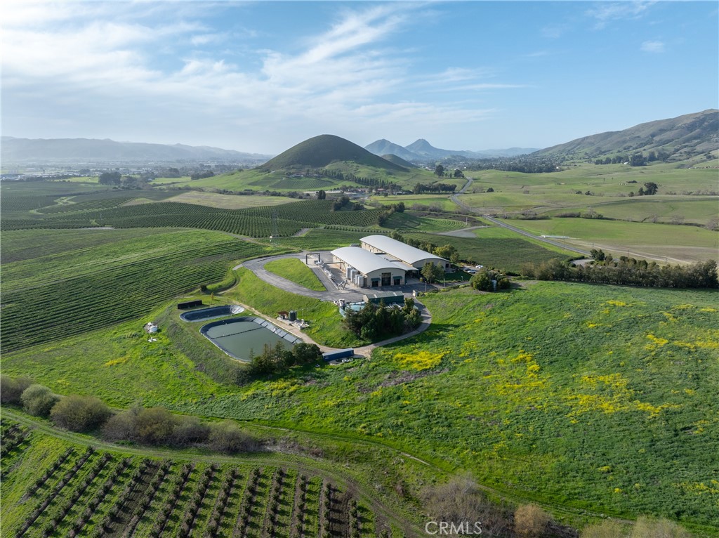 Exceptional winery production facility in the heart of Edna Valley AVA, located along the highly traveled Orcutt Road wine corridor. This turnkey estate features a 43,218± square foot production facility with an estimated 3,500-ton crush capacity, 435,000 gallons of NEW stainless steel jacketed temperate controlled tanks and ample barrel storage. The vineyard is planted to Pinot Noir, Chardonnay, and Syrah, with additional plantable ground for future growth. With panoramic views and an ideal setting for a tasting room or event venue, the property offers significant potential to expand direct-to-consumer sales and elevate brand visibility. Purpose-built for scale and efficiency, the facility includes climate-controlled barrel rooms, stainless steel tanks, and a new robust 1-million-gallon wastewater system. Positioned in one of California’s most prestigious wine regions, this property offers an unmatched opportunity to grow a premium wine brand while capitalizing on hospitality and event-driven revenue.